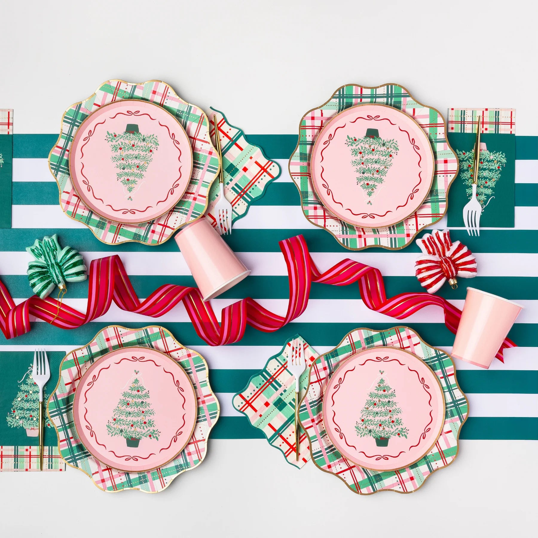 Holiday tablescape with plaid plates and Christmas tree napkins styled for festive Christmas party decorations.