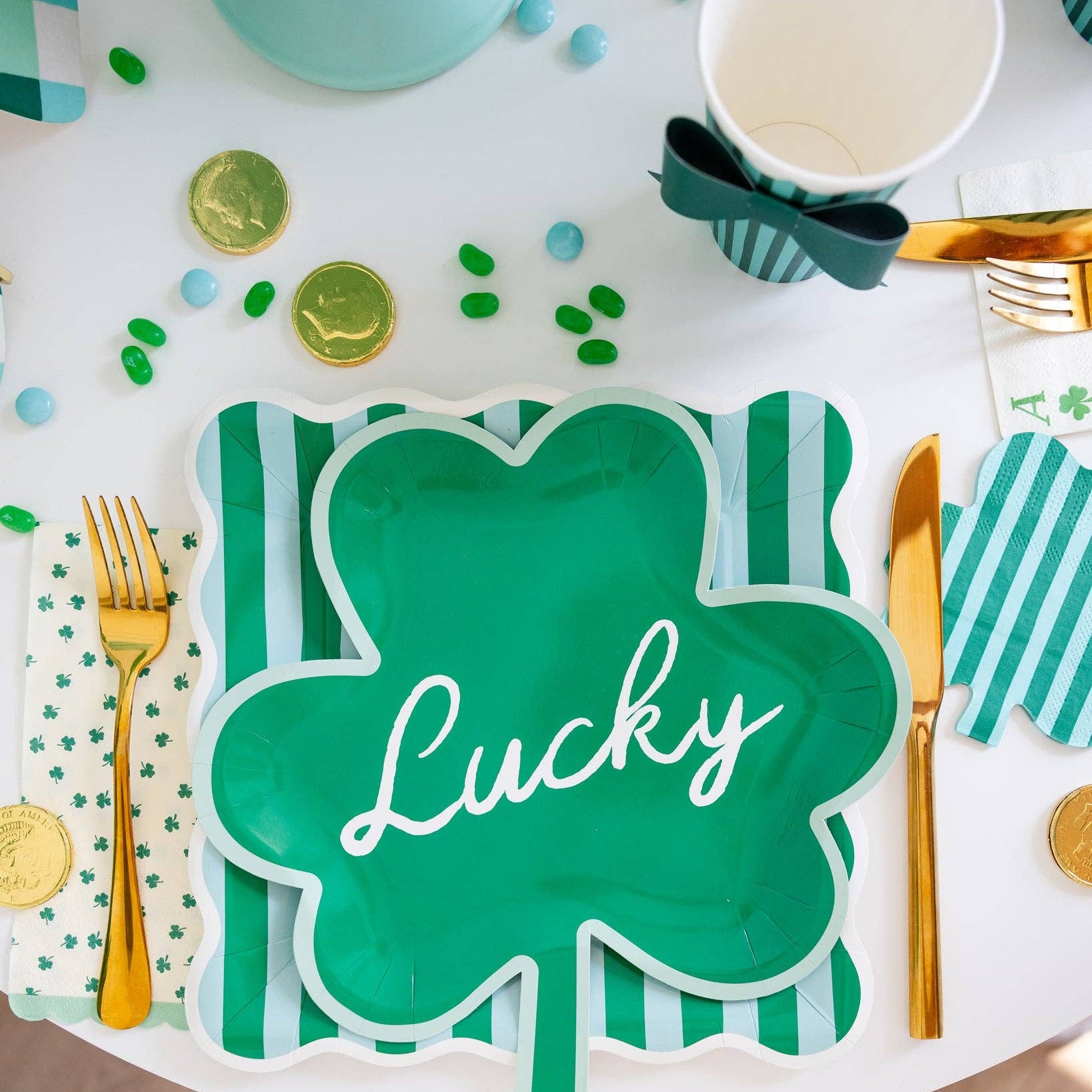 St. Patrick’s Day table setting with clover dinner napkins, shamrock plates, and green accents