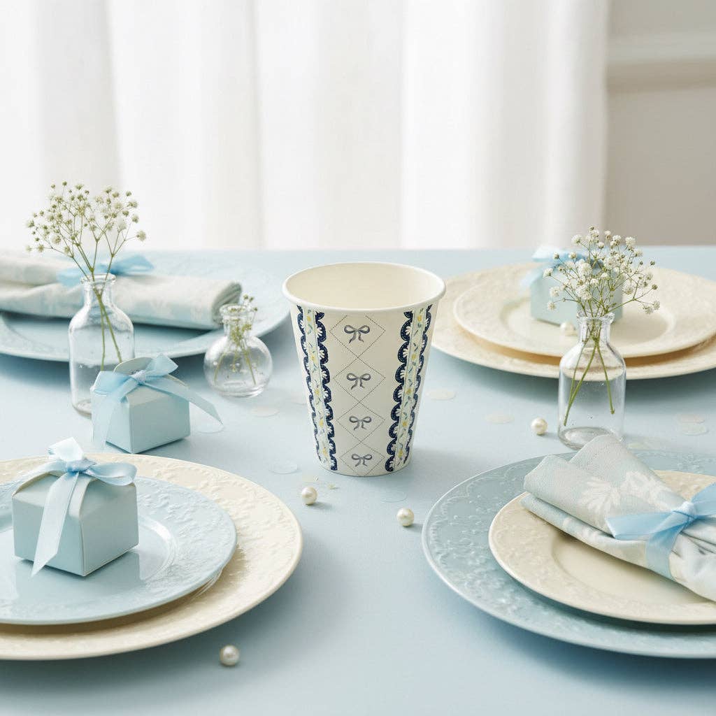 Blue party cup styled on a tablescape with light blue plates and gift boxes