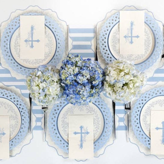 A sophisticated Coastal Communion table setting with light blue lattice edge plates and blue cross guest towels.