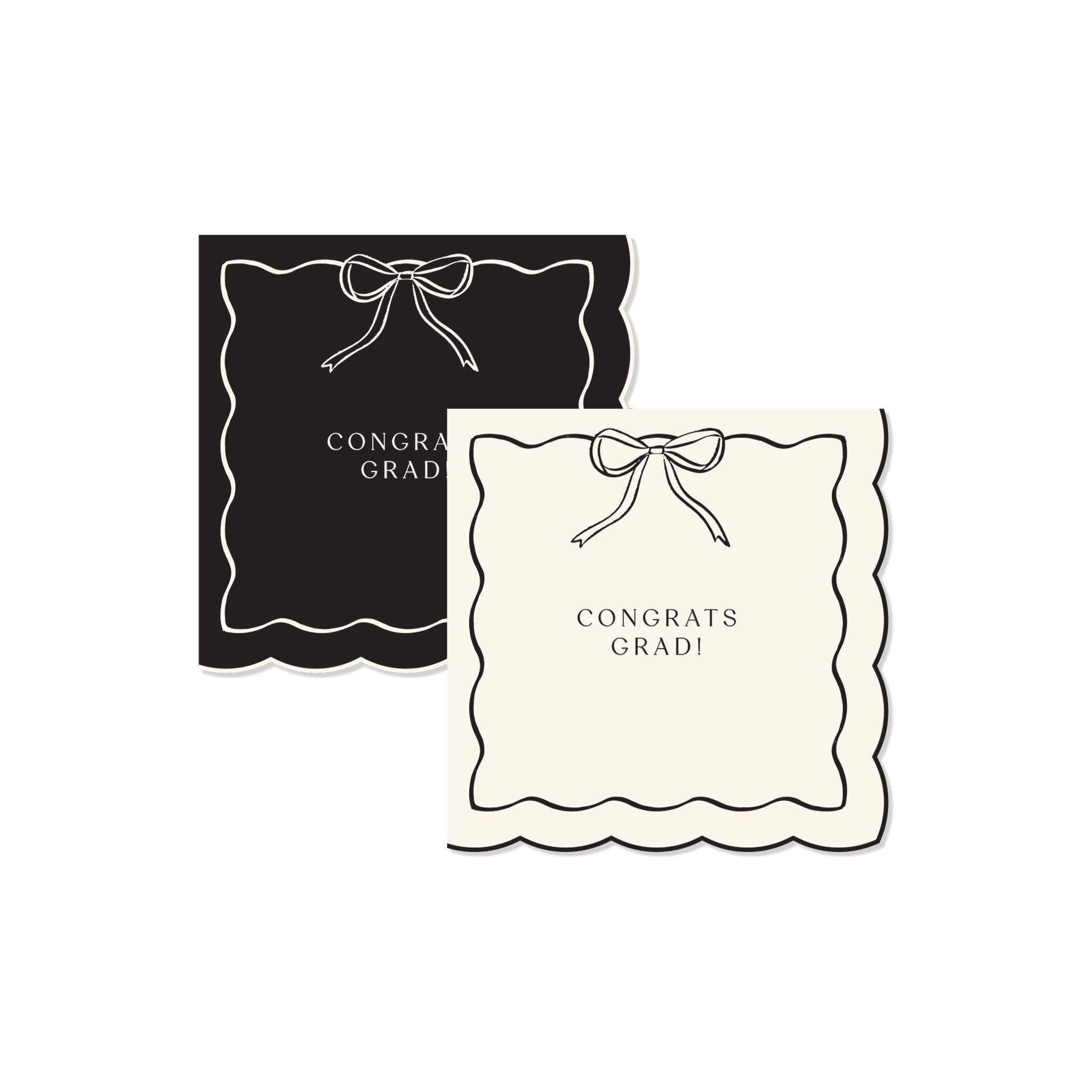 A set of black and cream Congrats Grad napkins with a scalloped edge and a Gold Foil Detail bow for a Preppy Grad celebration.