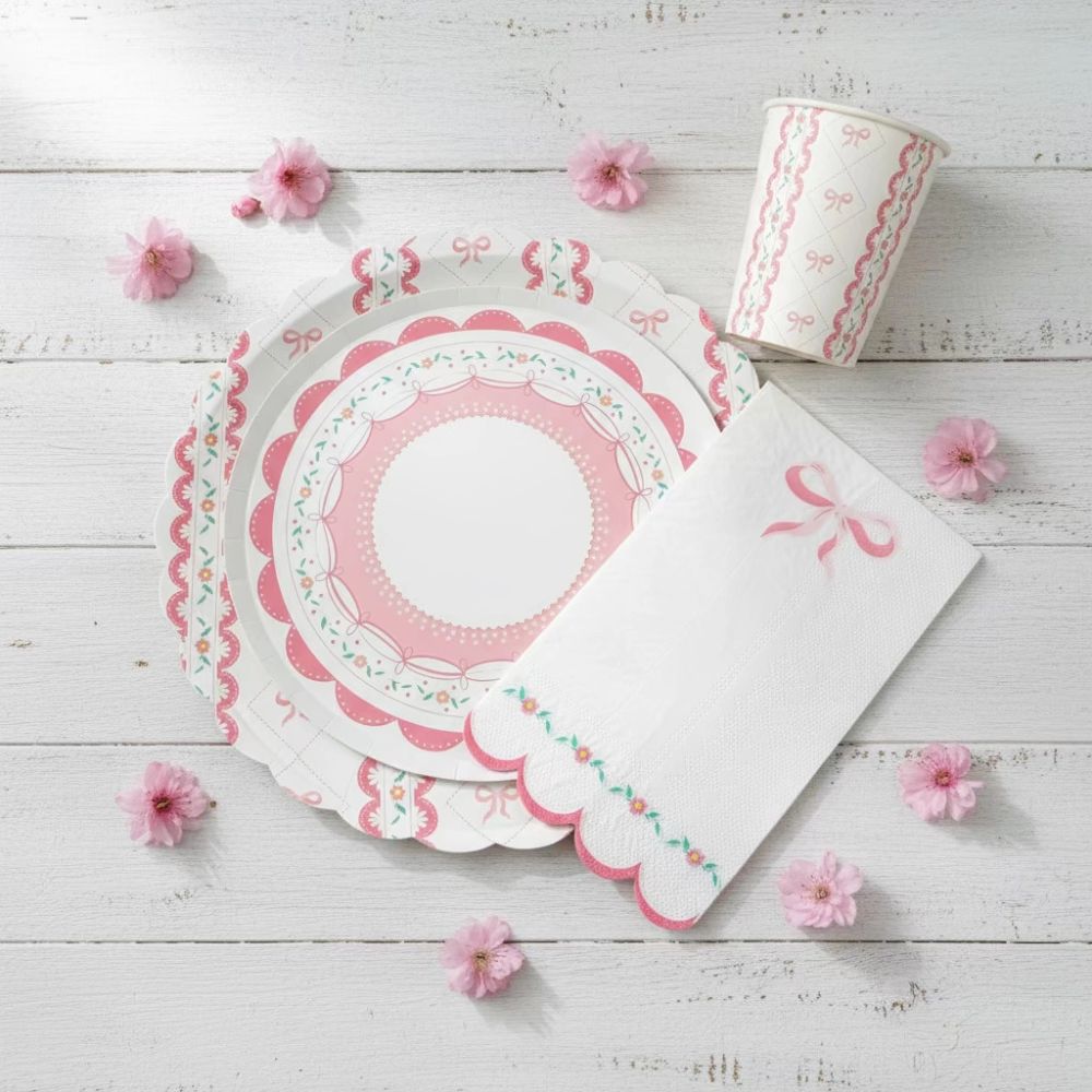 Stacked partyware with a large bow plate, small lace plate, and cup