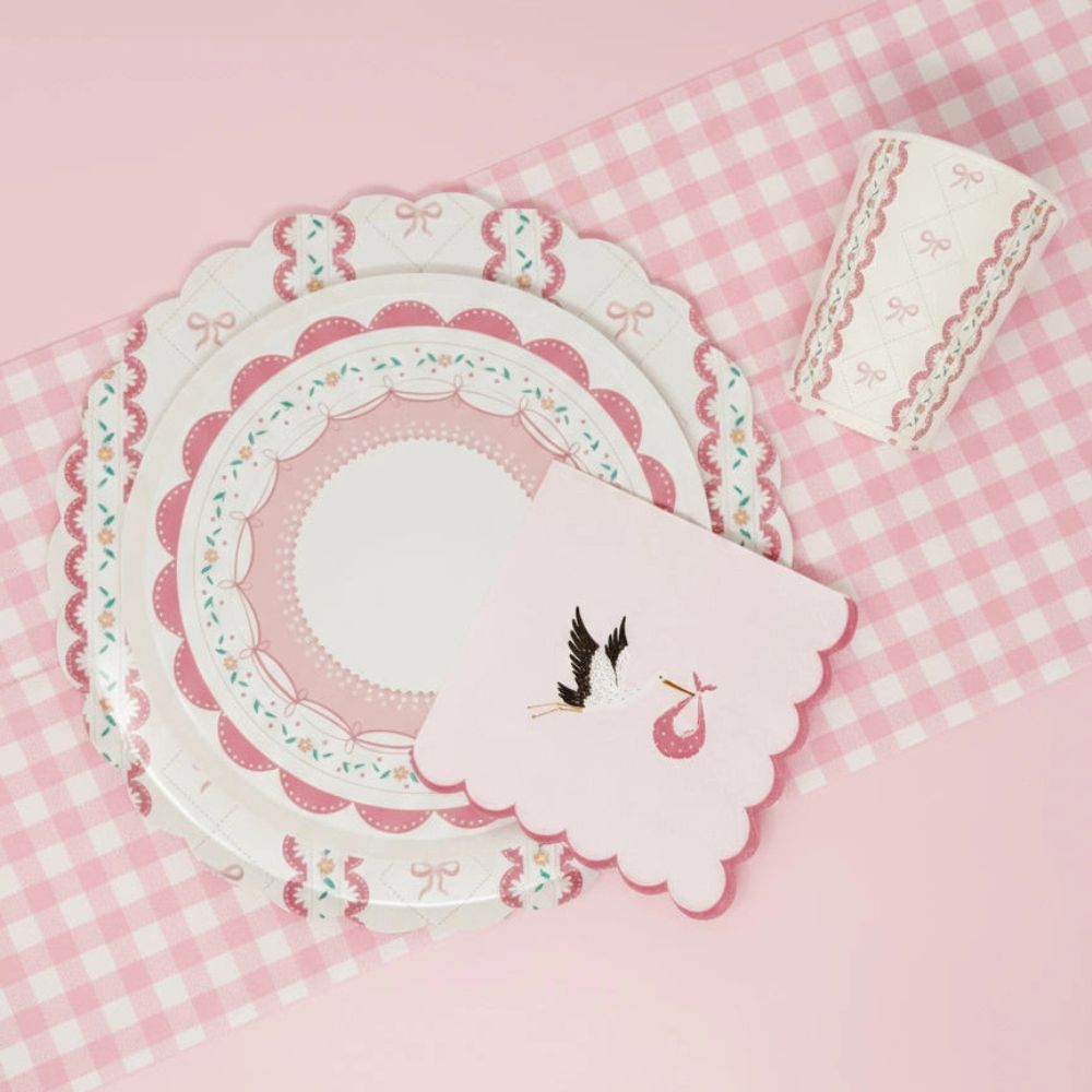 Lace dessert plate and stork napkin on a pink gingham runner