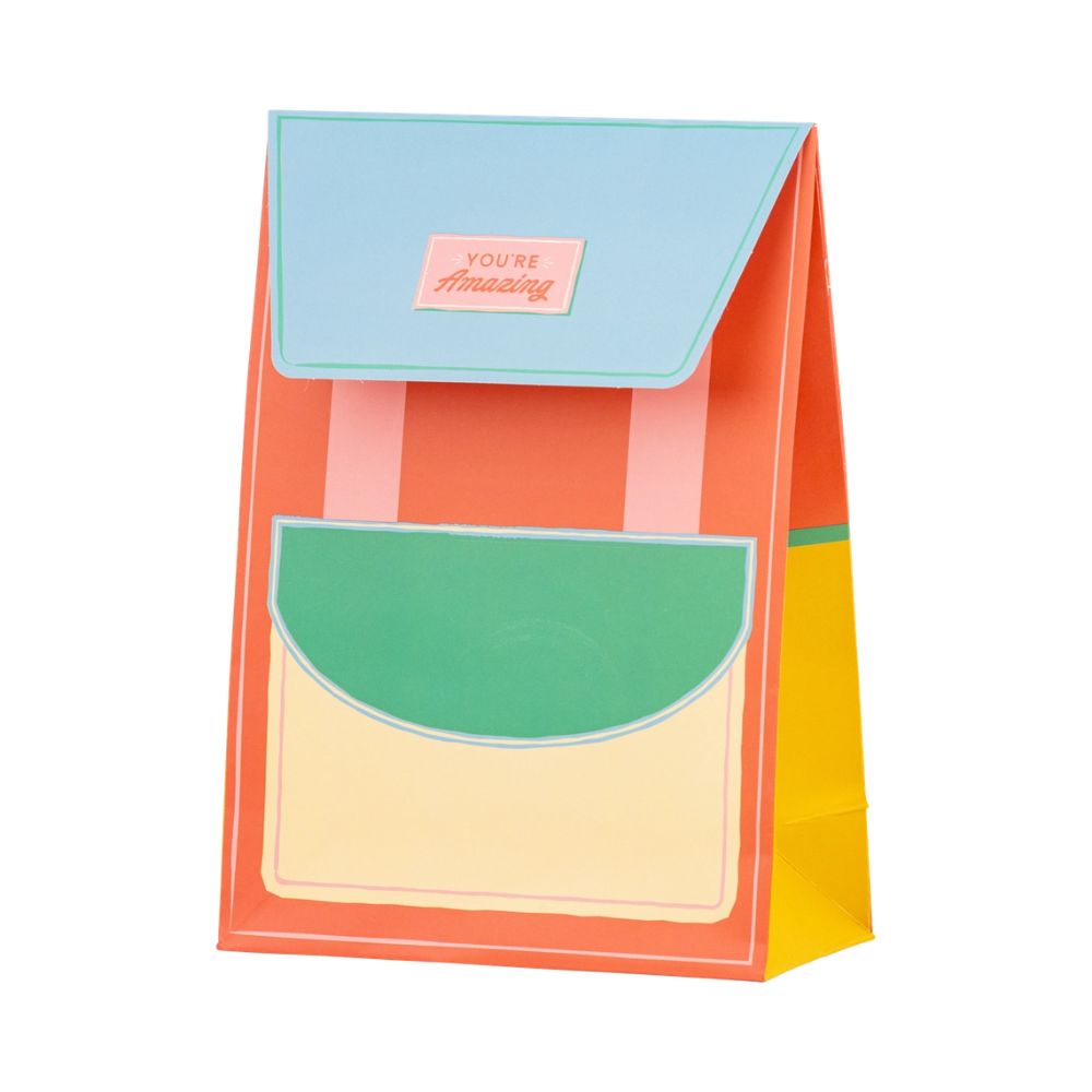 Coral and blue backpack-shaped treat bag standing upright.