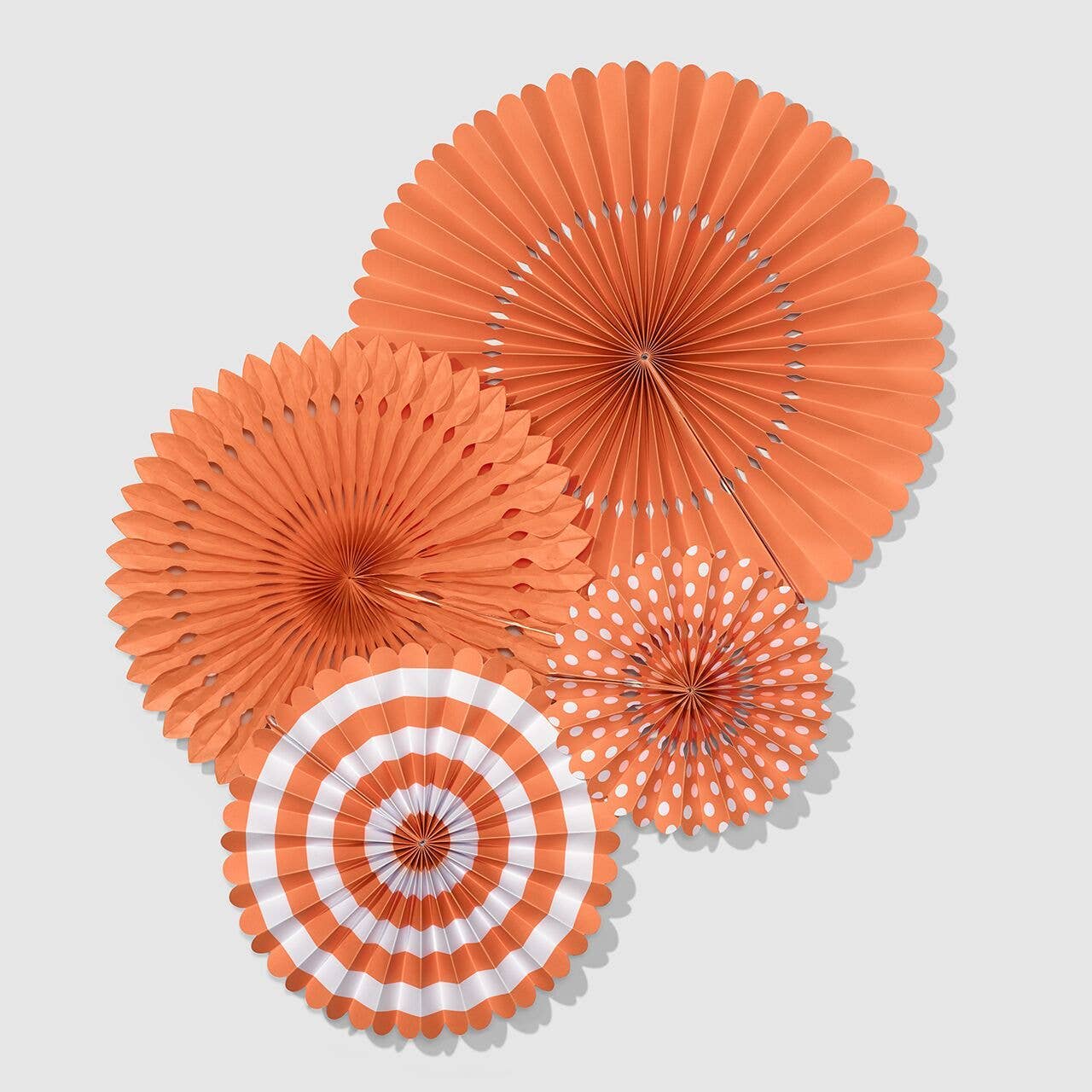 A cluster of four Tropical Party Fans in orange, coral, and white, showing the 3D Paper Fan Wall Idea layering.