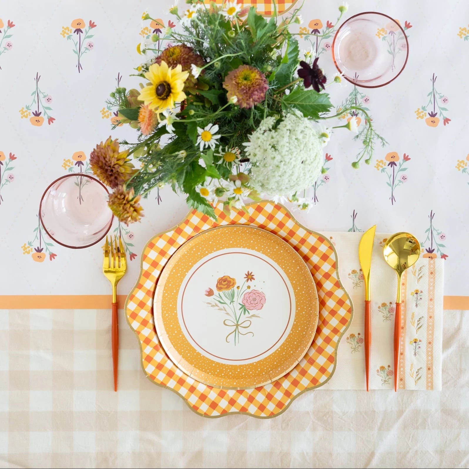 Side angle of the floral paper runner highlighting the warm colors and scalloped plates on top.