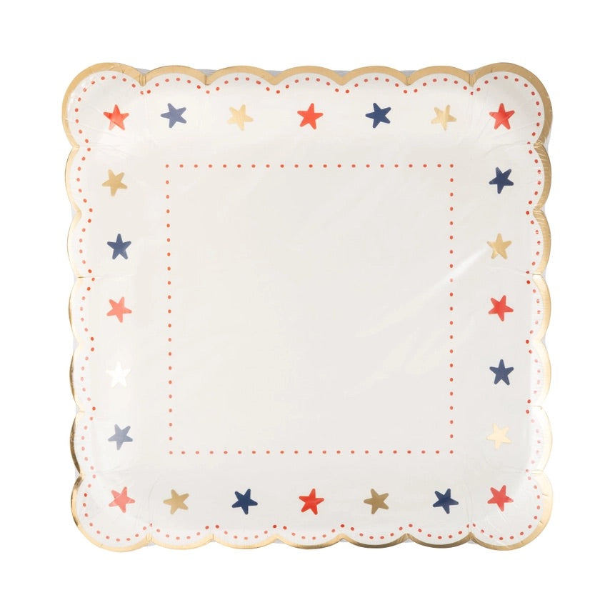 Packaged set of elegant scalloped paper plates with festive star pattern and gold foil trim for a stylish 4th of July event.