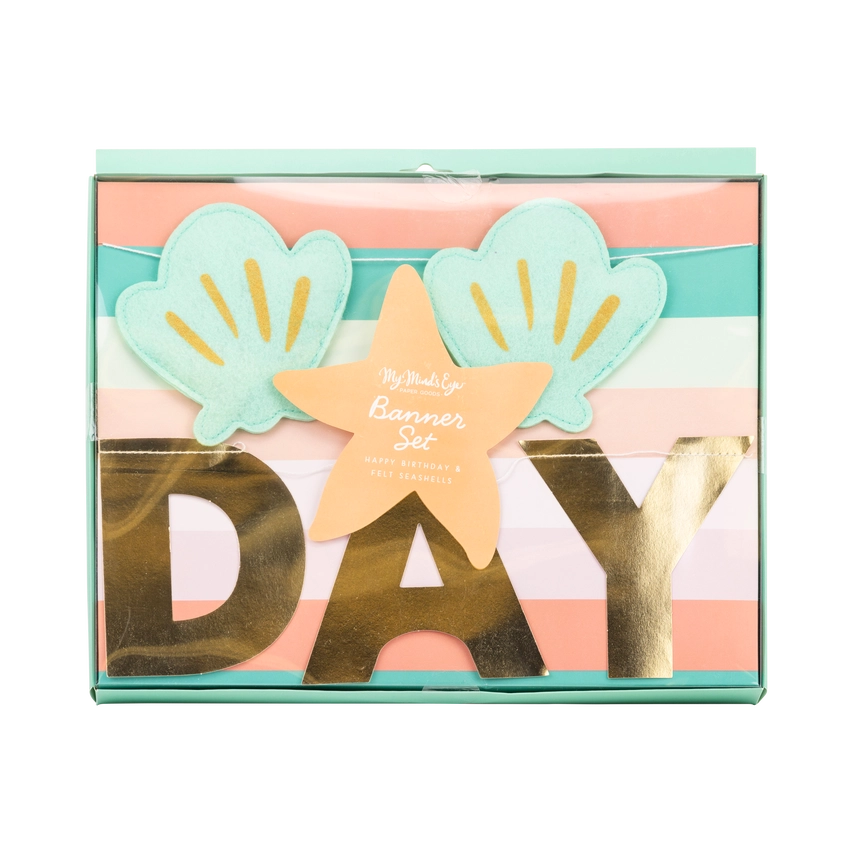 Close‑up of boxed banner set featuring felt shells, gold letters, and starfish‑shaped label.