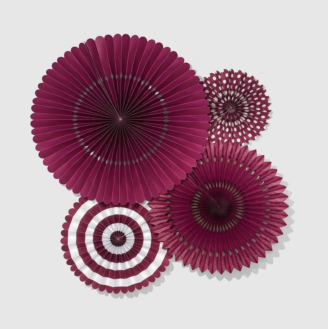 A set of four plum and dark purple accordion hanging fans in various sizes and patterns, including polka dots and stripes.