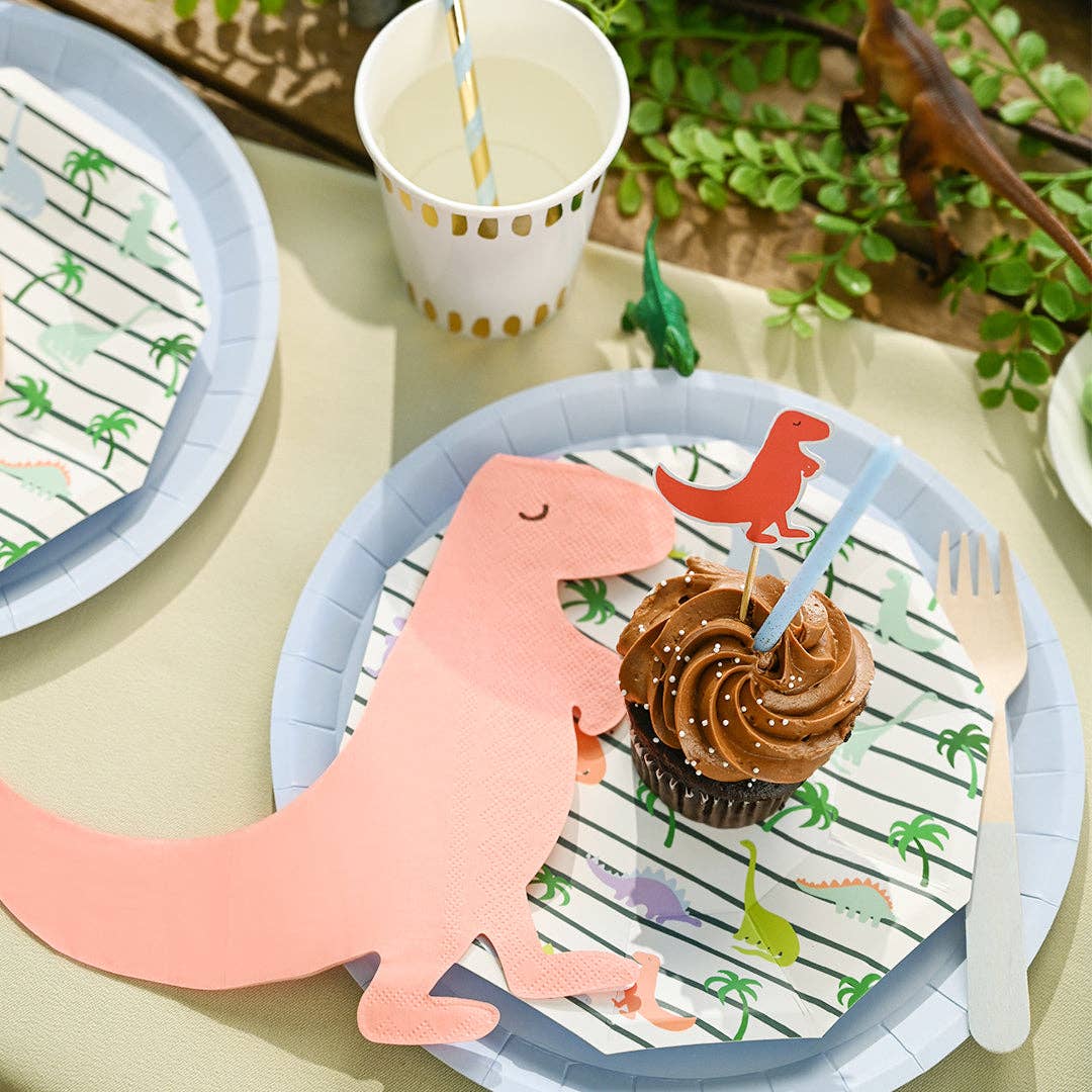 Close-up of dinosaur plate with cupcake and party napkin.