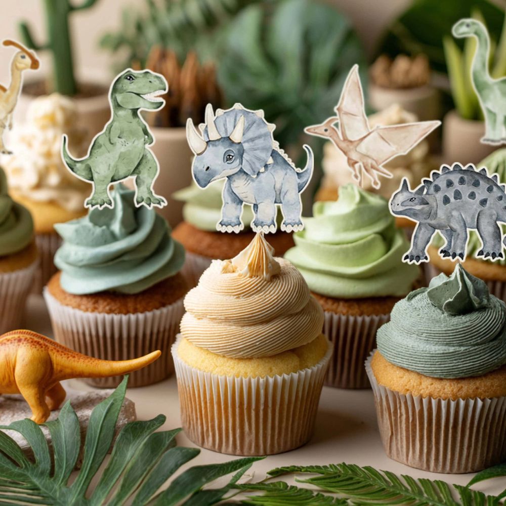 Dinosaur cupcake toppers on frosted cupcakes with green icing

