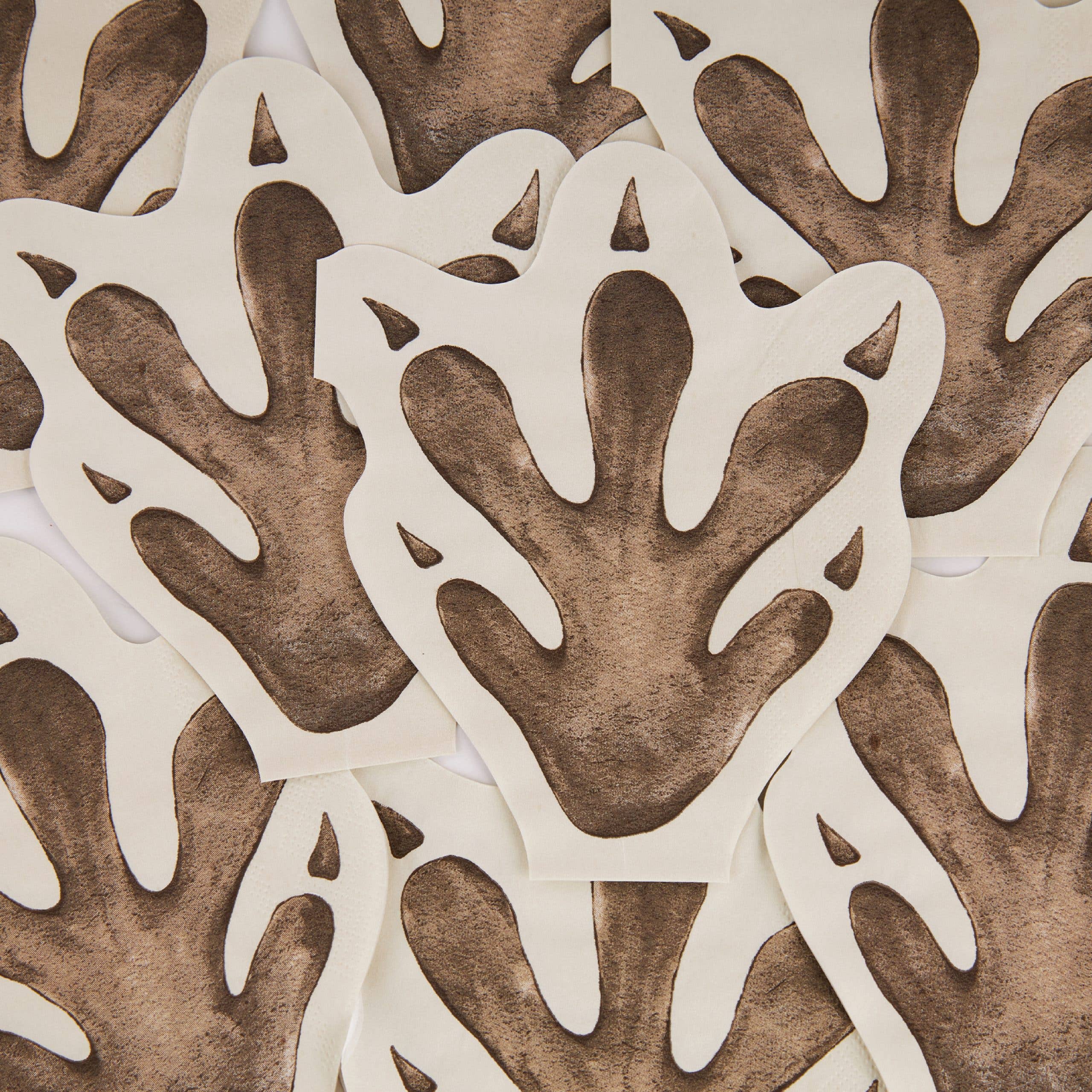 Stack of dinosaur footprint napkins layered together
