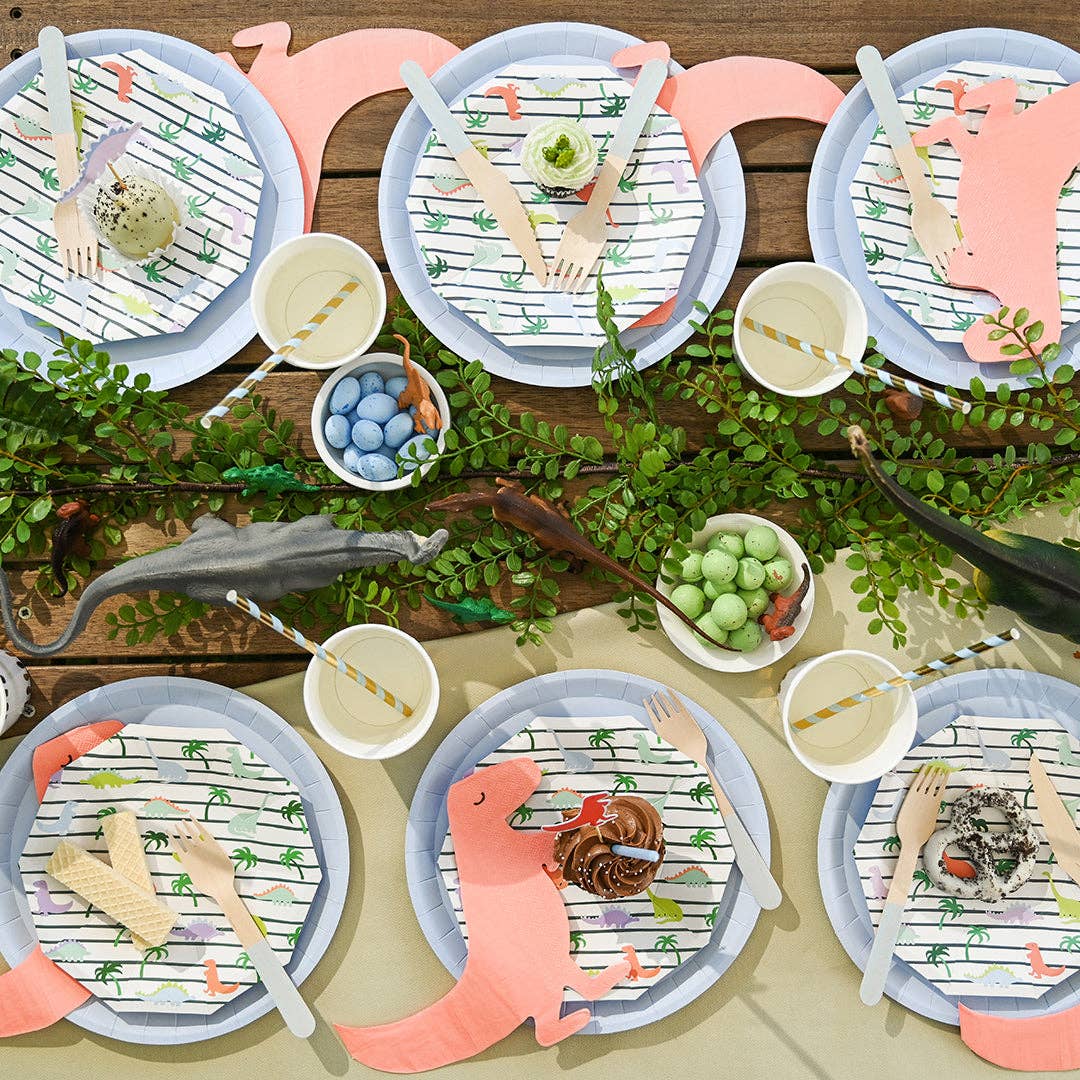 Dinosaur party table setup with themed plates and decorations.