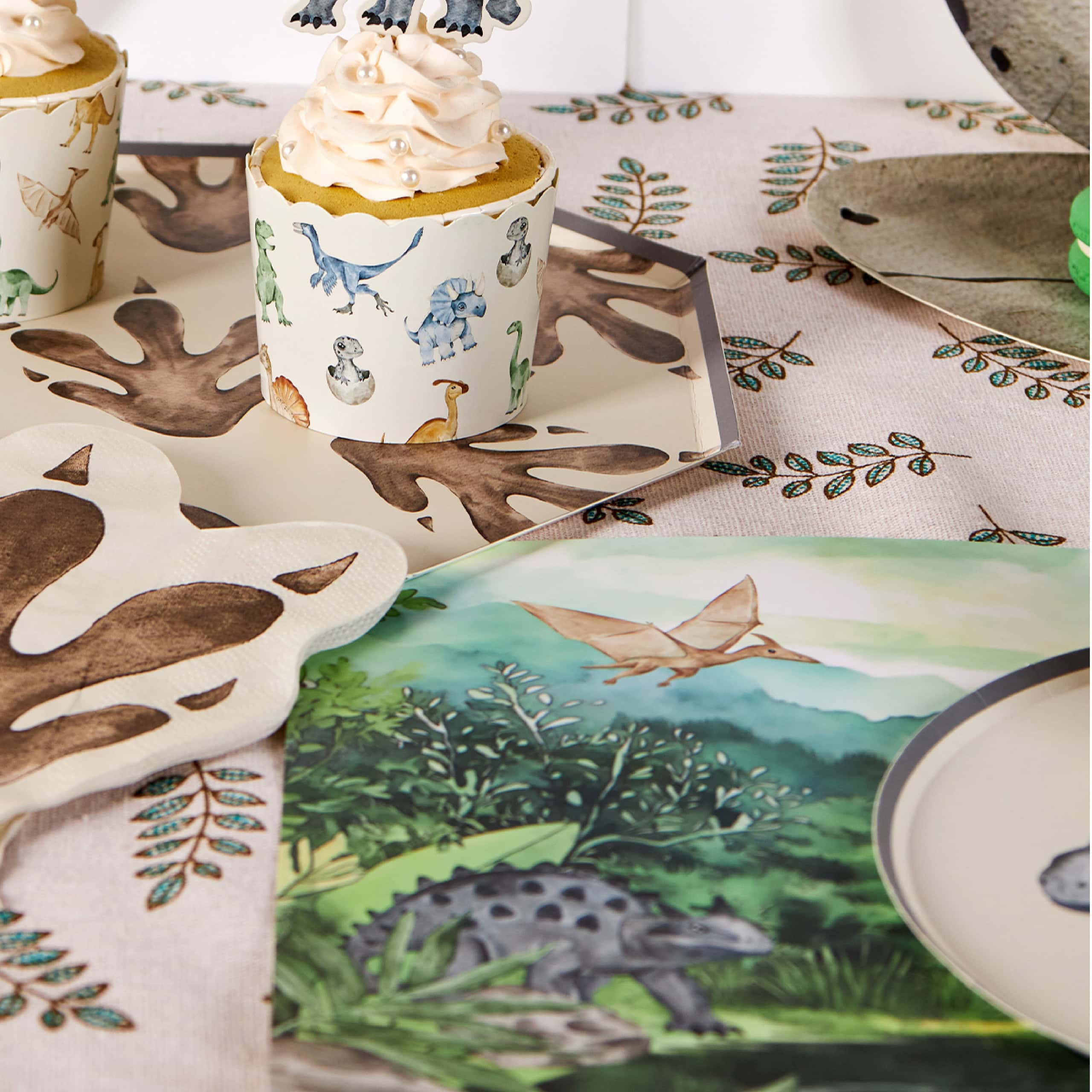 Close-up of dinosaur placemat with party plates and napkins
