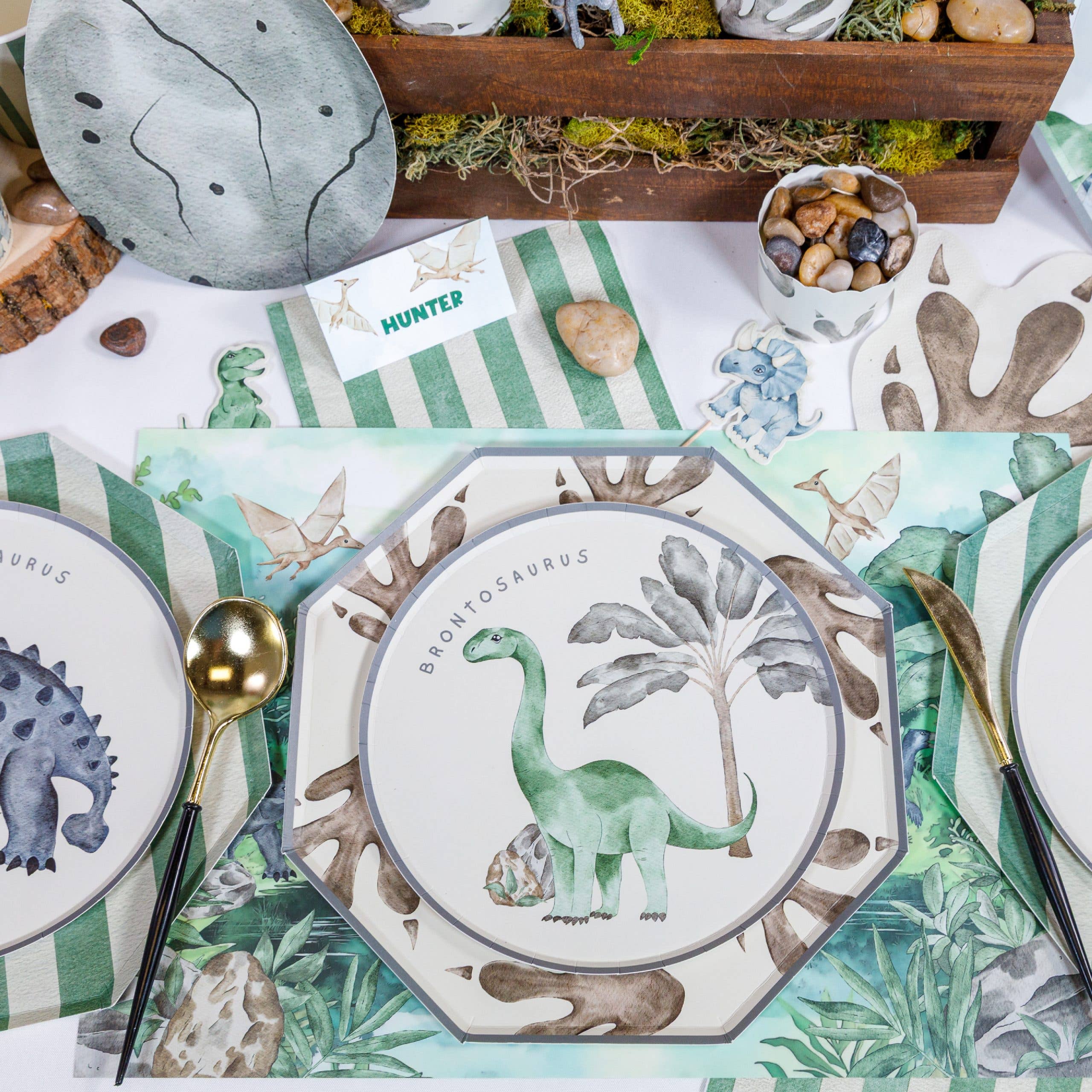 Dinosaur jungle placemat displayed with full party table setup