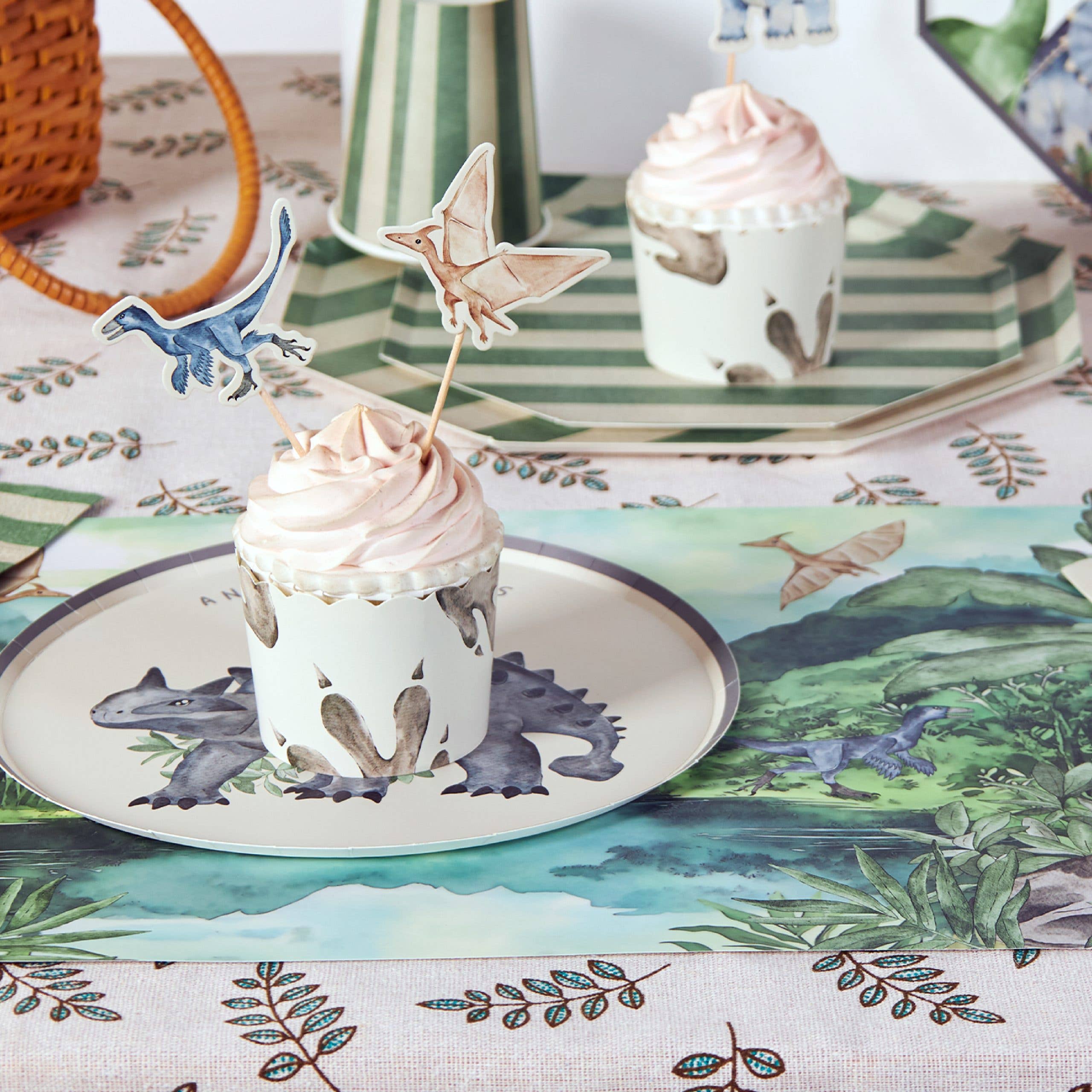 Dinosaur placemat styled with cupcake and party tableware
