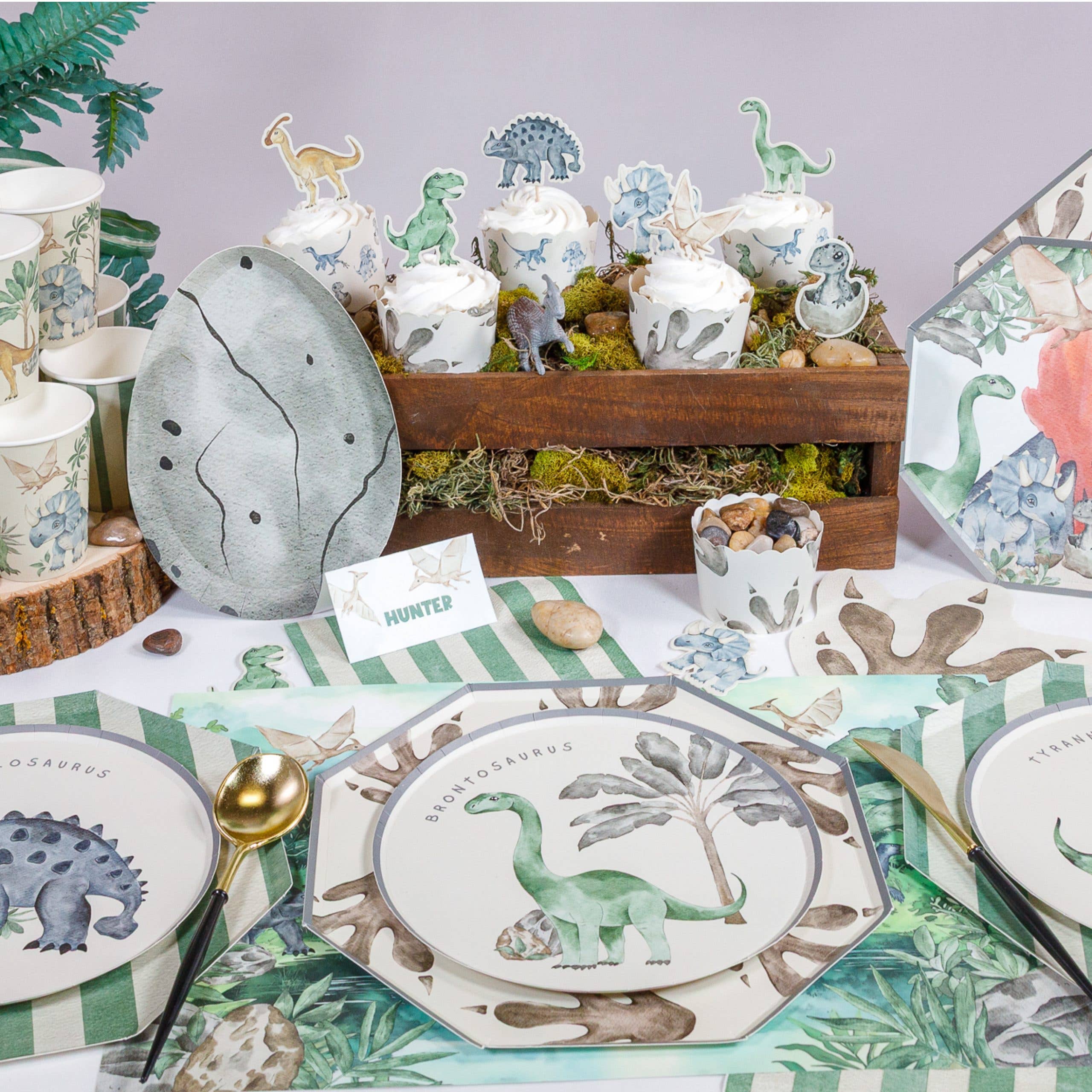 Dinosaur party table setup with placemats and themed decor
