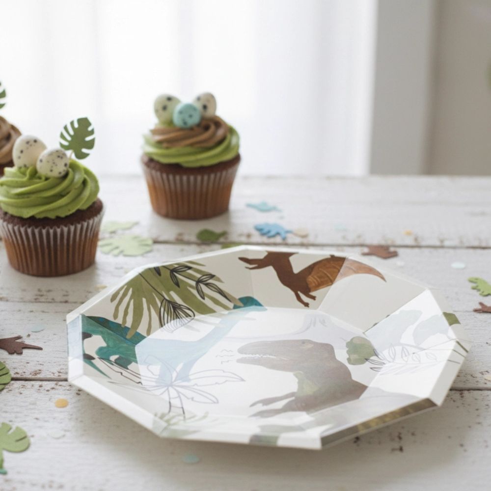 dinosaur plate with cupcakes and party setup in background
