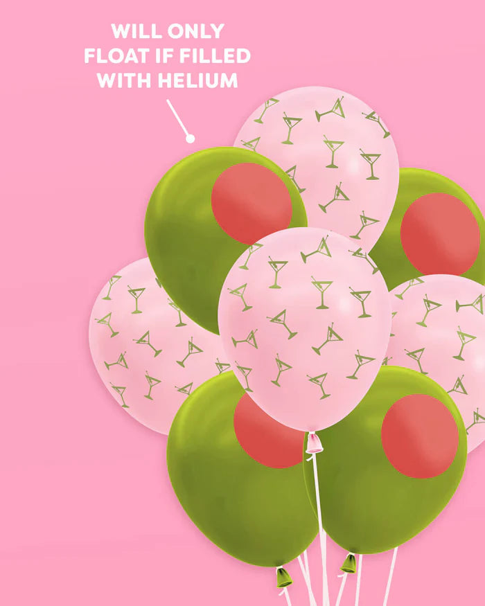 Cluster of pink martini and green olive latex balloons floating on pink background with callout reading will only float if filled with helium