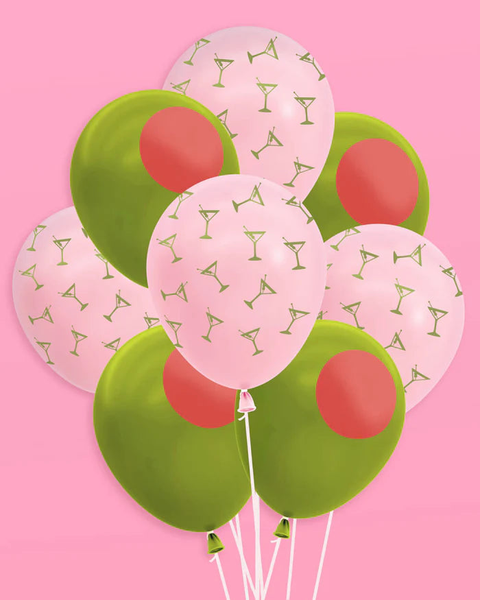 Bouquet of pink martini and green olive latex balloons arranged on pink background showing full mix of both designs
