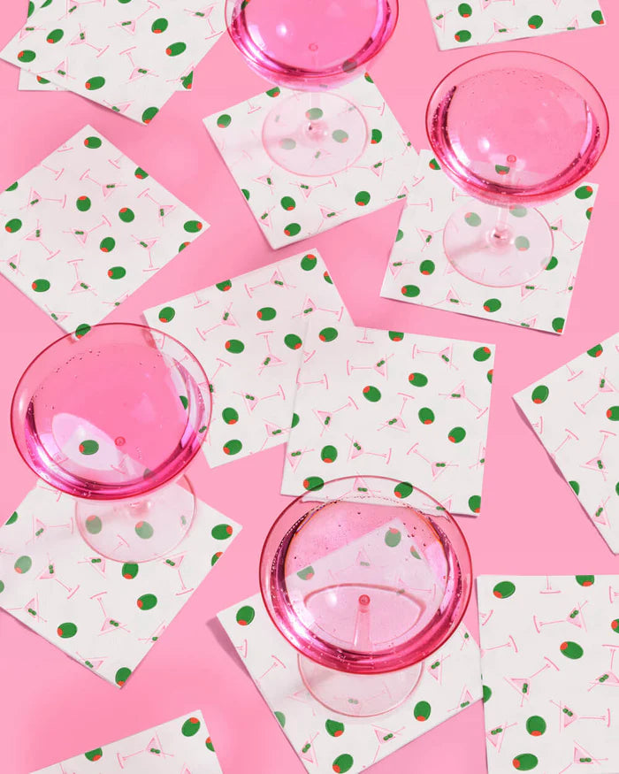 Dirty martini print paper cocktail napkins with pink martini glasses on a pink background