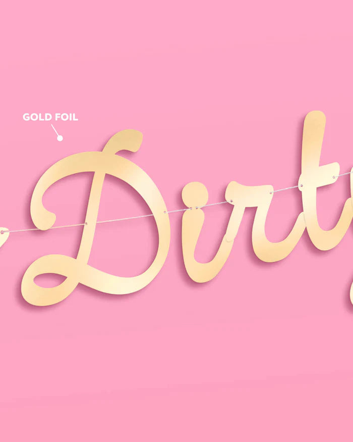 Close-up of gold foil "Dirty" cursive lettering on the Dirty Thirty 30th birthday banner, with gold foil finish detail labeled