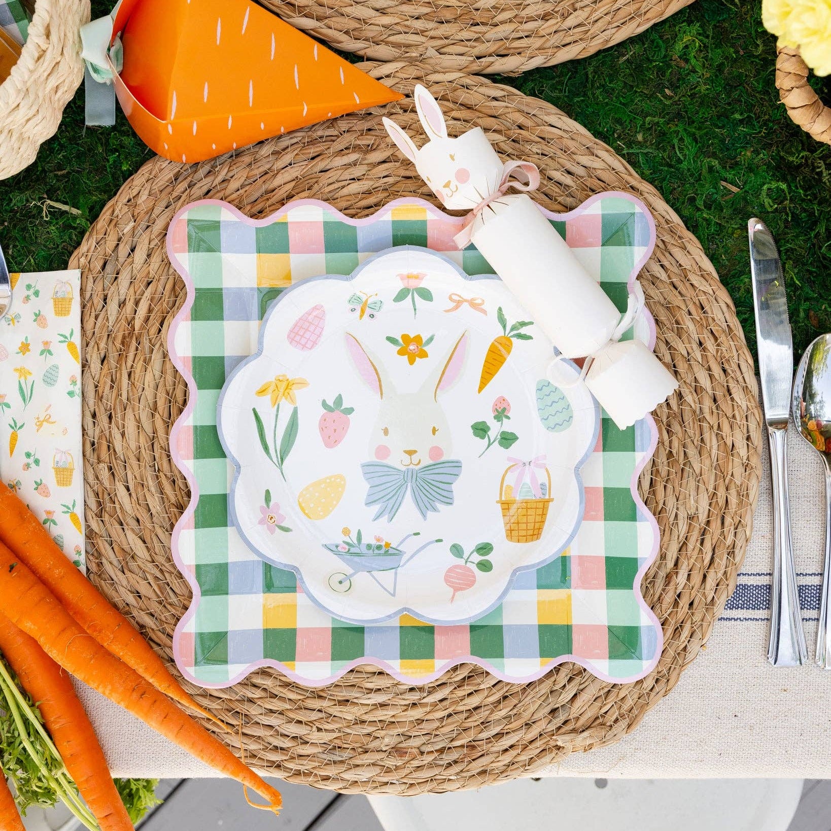 Overhead view of Easter icons plate styled with carrots and spring decor