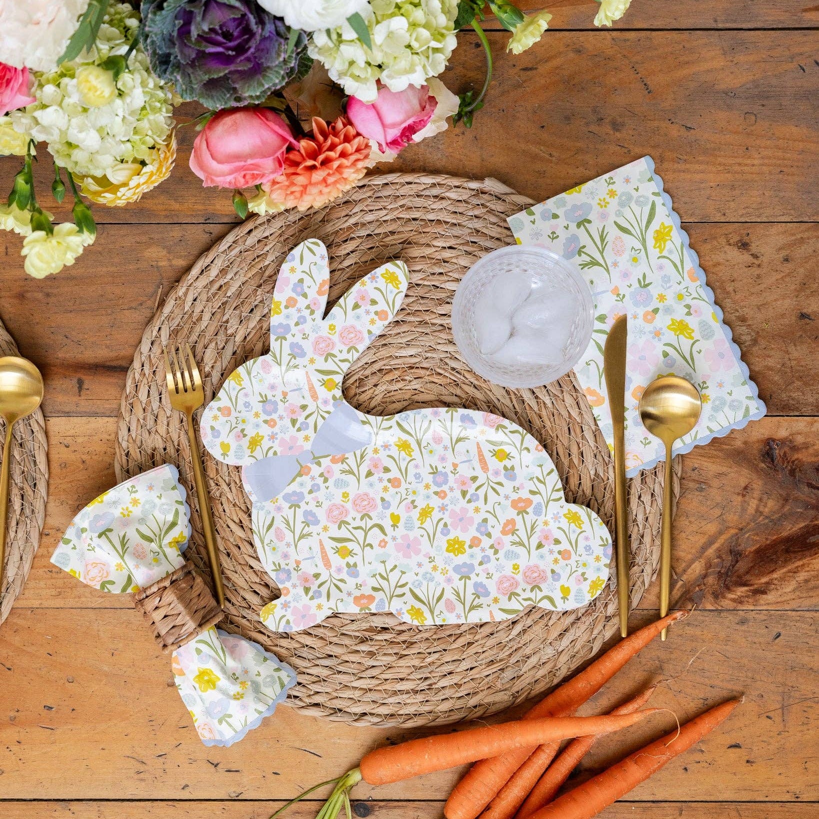 Spring table setting with floral Easter napkins, bunny plate, and garden décor.