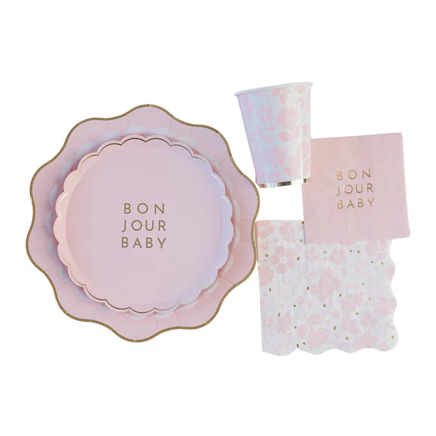 Flat‑lay of full Bonjour Baby party kit showing nested plates, floral cup, gold‑foil napkins and Emma Bear lunch napkins.