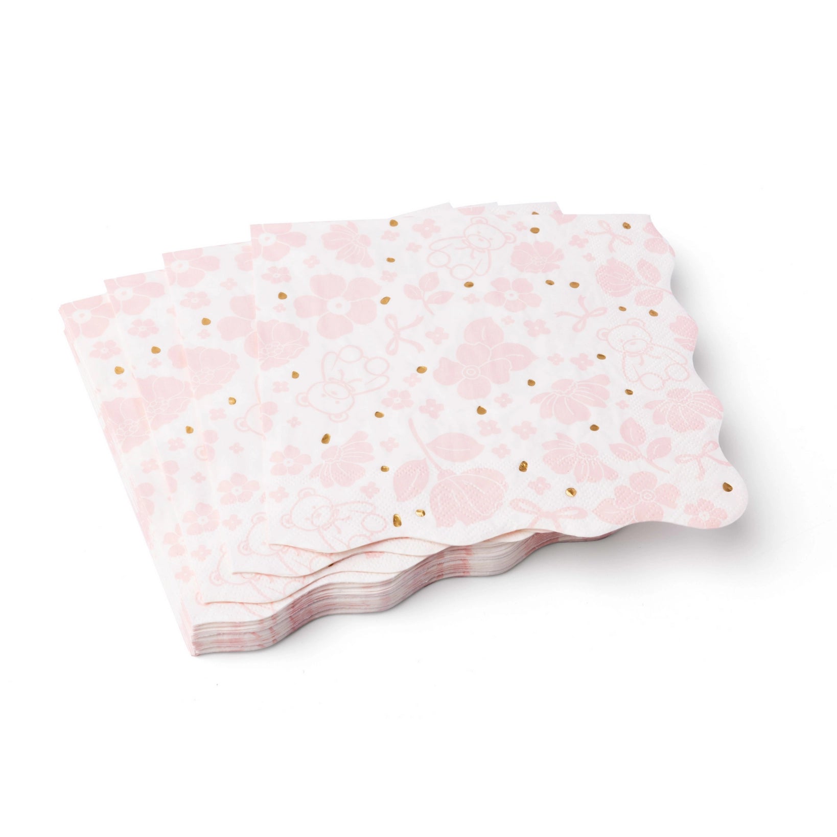 Stack of pink paper plates with gold polka dots on a white background