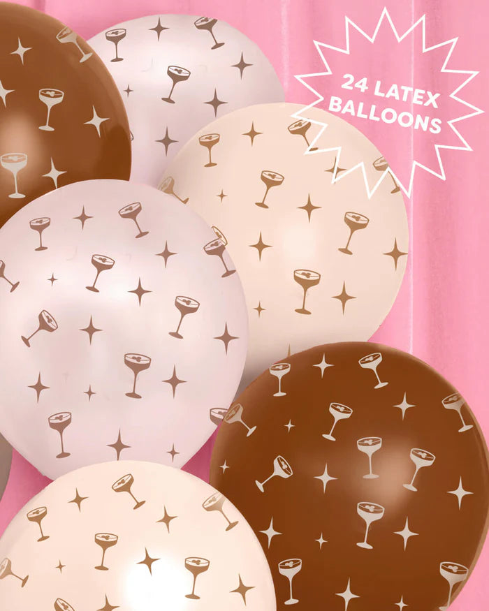 Close-up arrangement of six espresso martini print party balloons in brown, blush, and cream against a pink background with a badge reading "24 Latex Balloons"