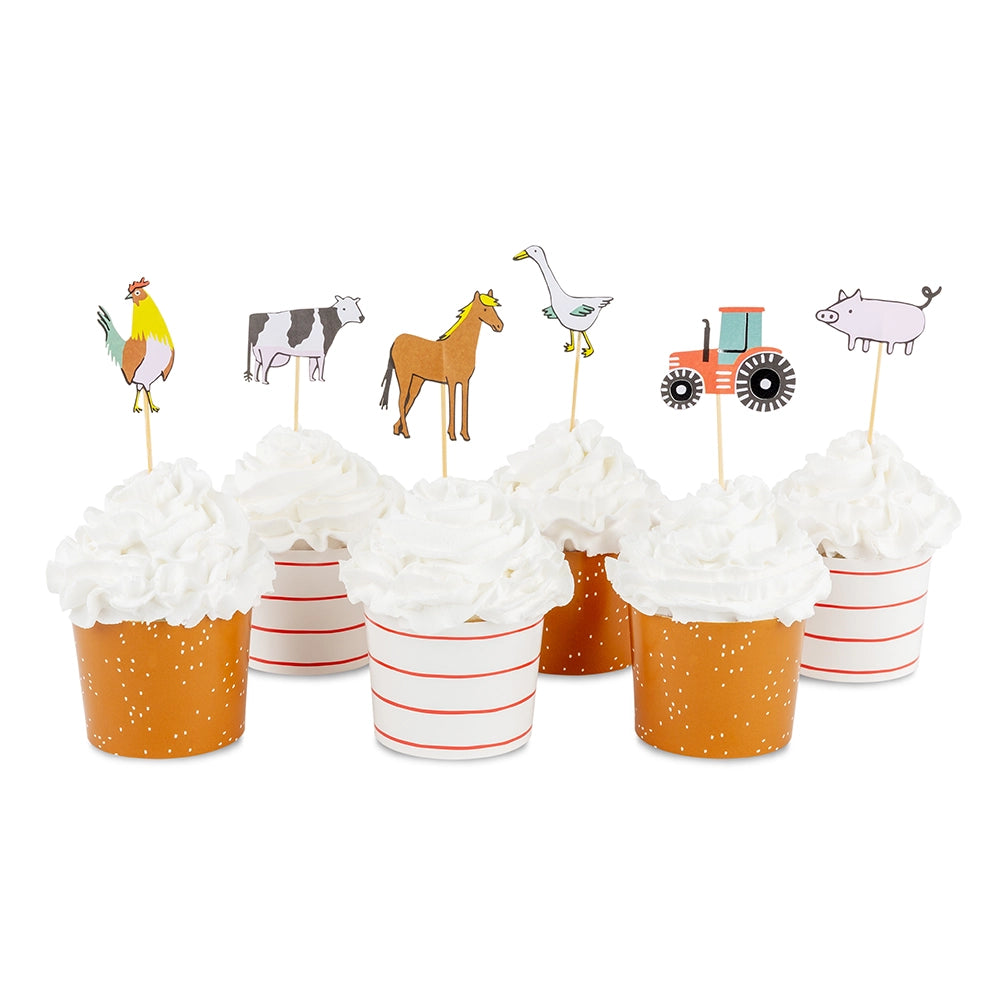 six frosted cupcakes in striped and speckled cups topped with rooster, cow, horse, goose, tractor, and pig picks.