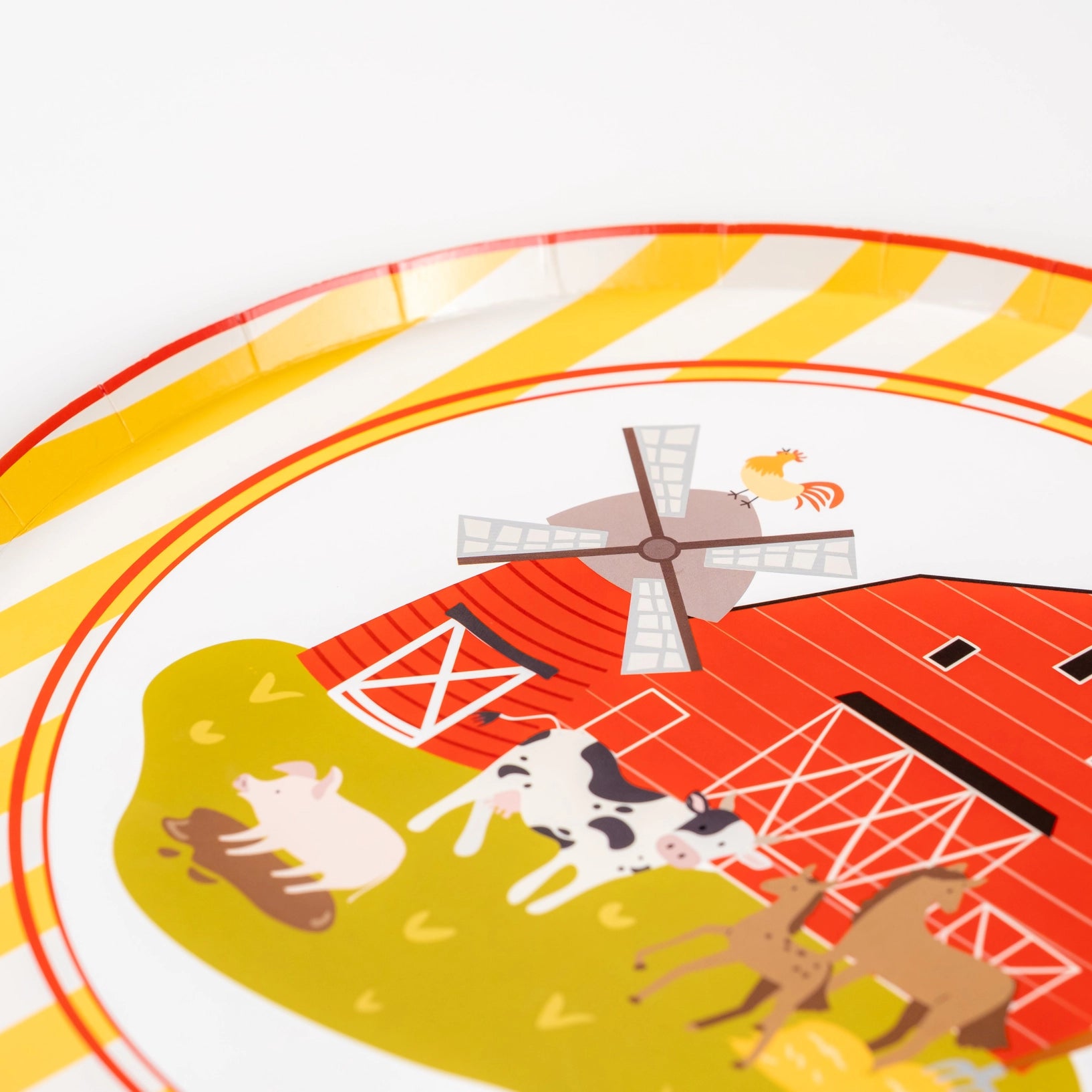 Close-up of red barn plate with windmill and farm animals—perfect for a farm birthday party.
