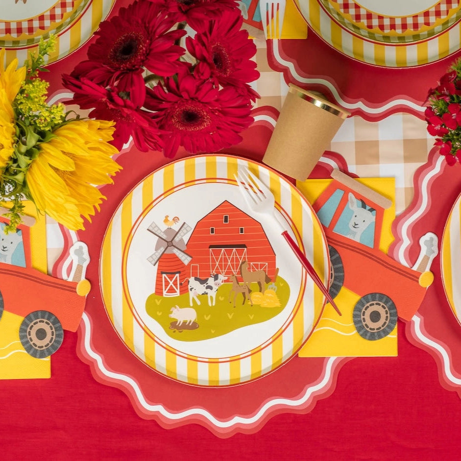 Barnyard tablescape with sunflower centerpieces and farm plates.