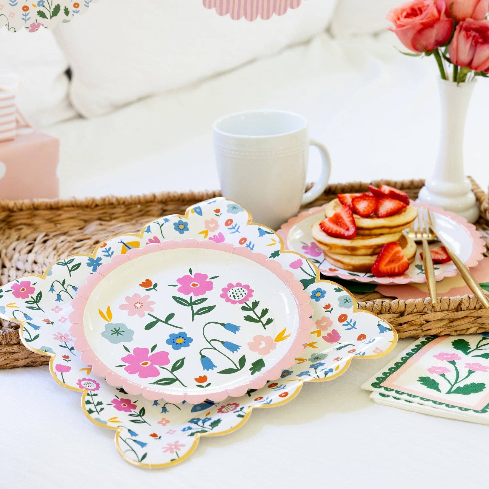 Floral spring plates styled on a brunch table with pancakes and flowers