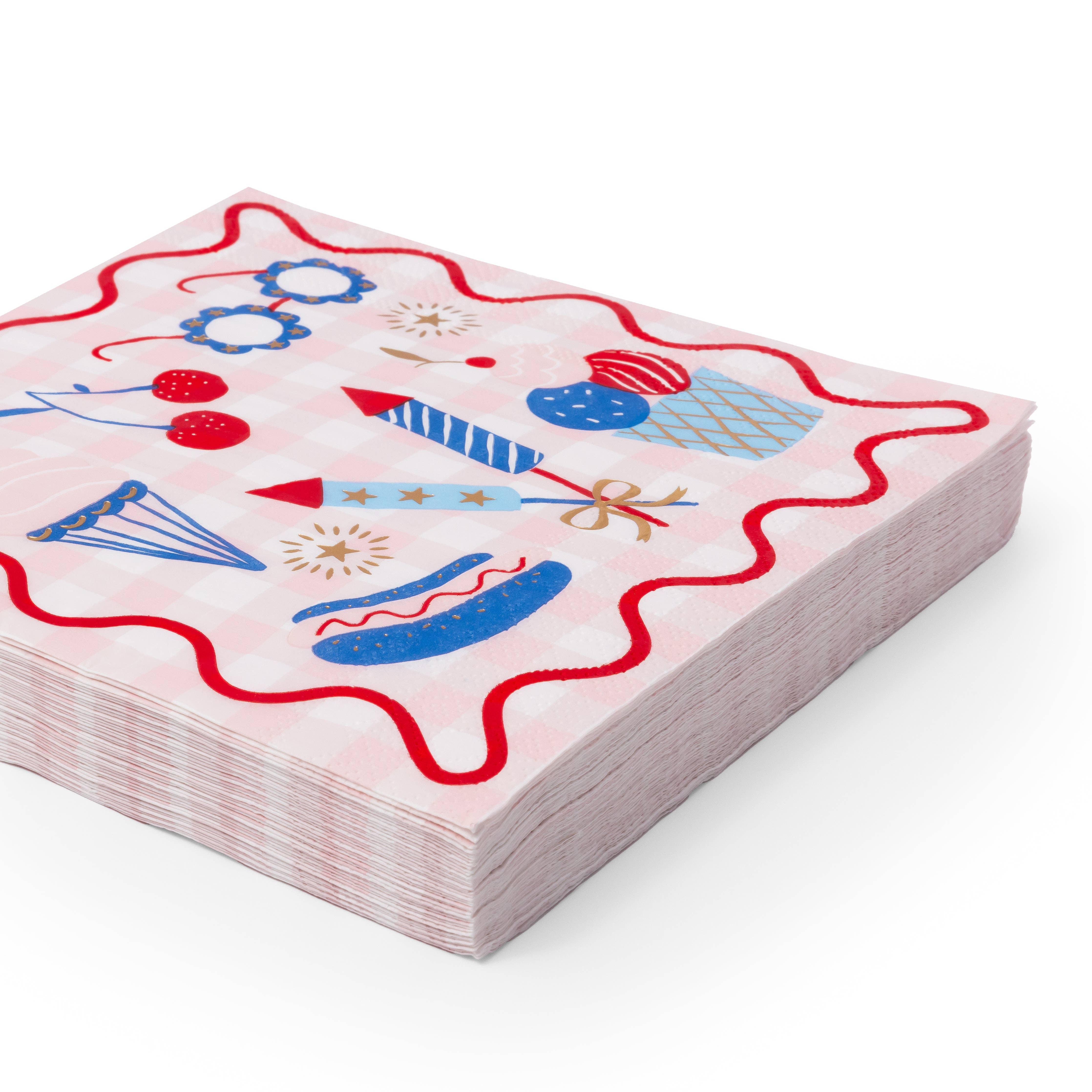 stack of 4th of july paper napkins showing patriotic food and fireworks design.