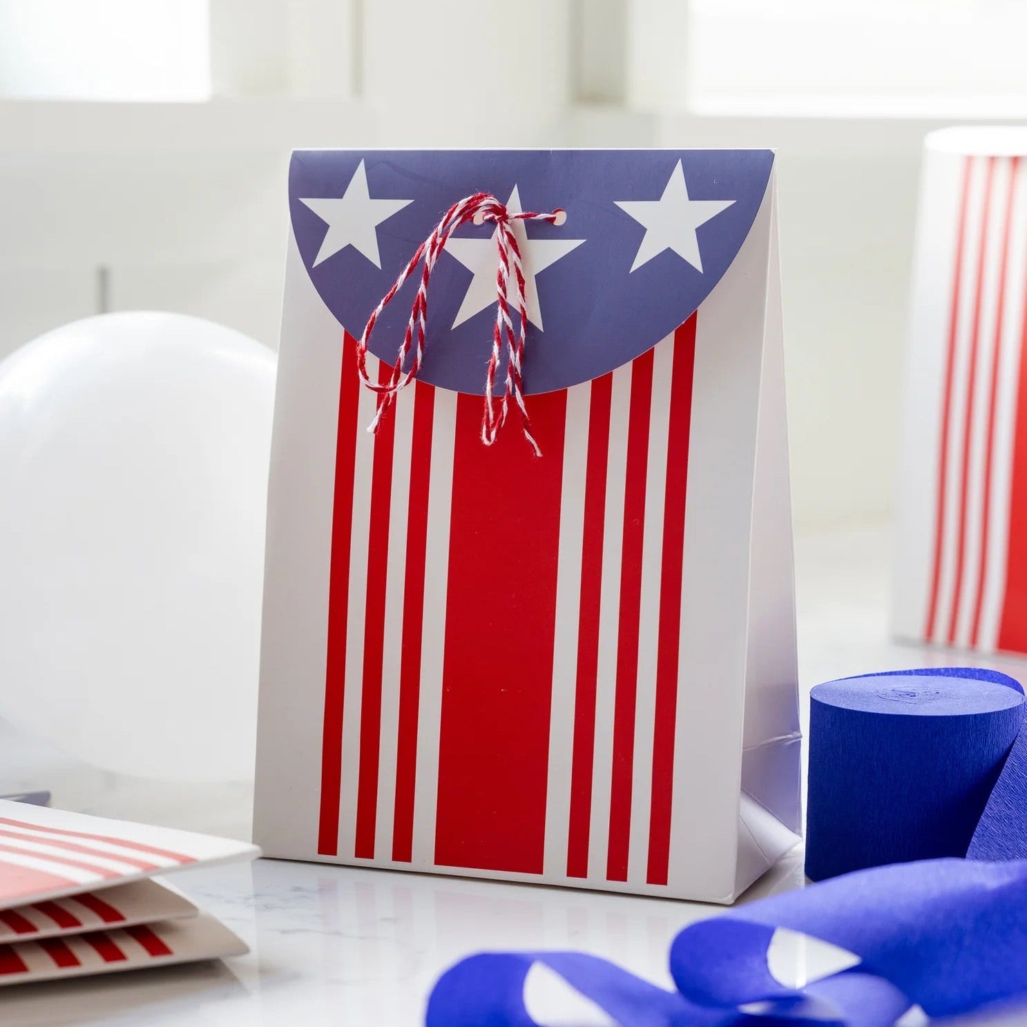 Close-up of a patriotic treat bag tied with red and white baker’s twine, great for filling with candy or small toys.