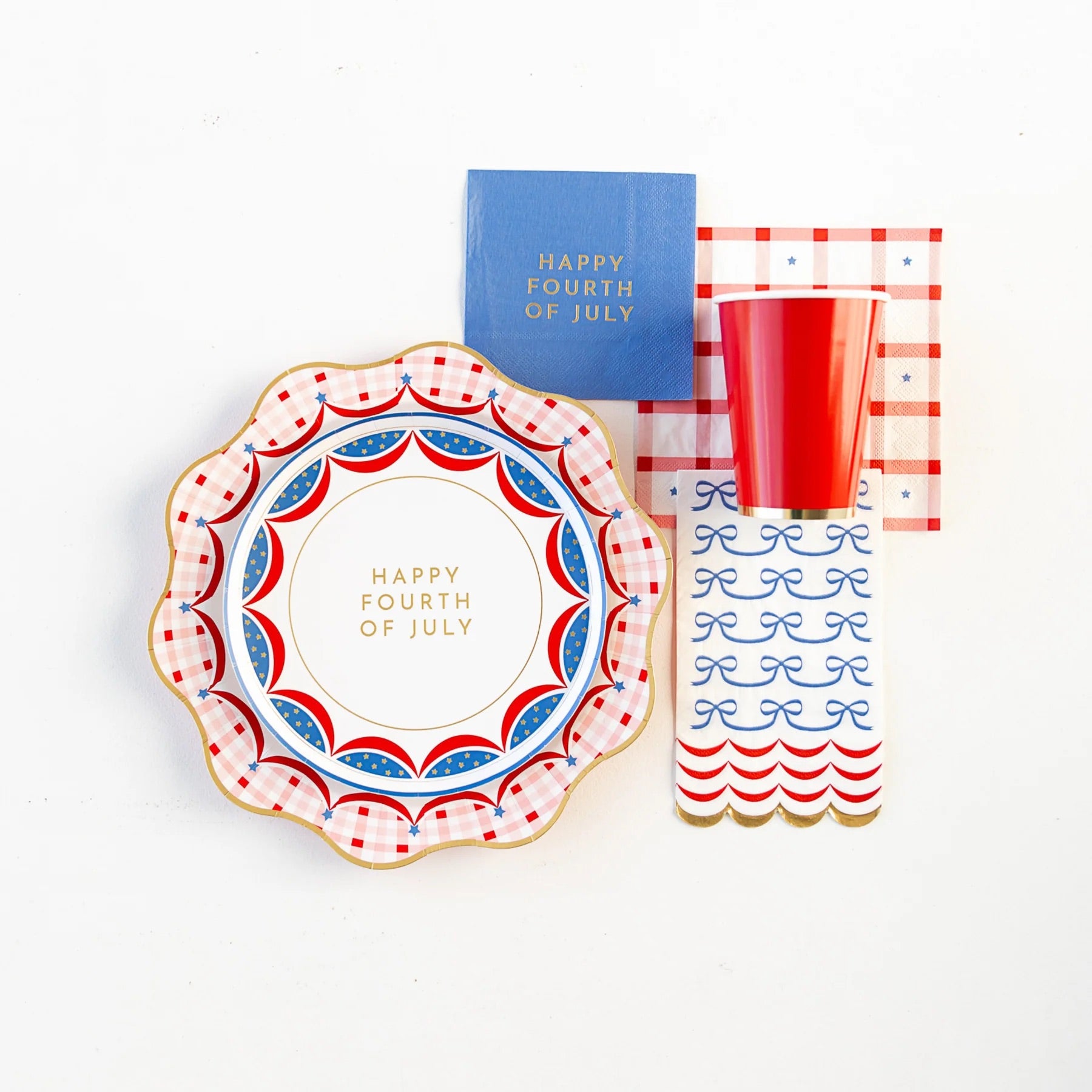 Red Gingham 4th of July Dinner Plates set next to BBQ classics like ribs and coleslaw.