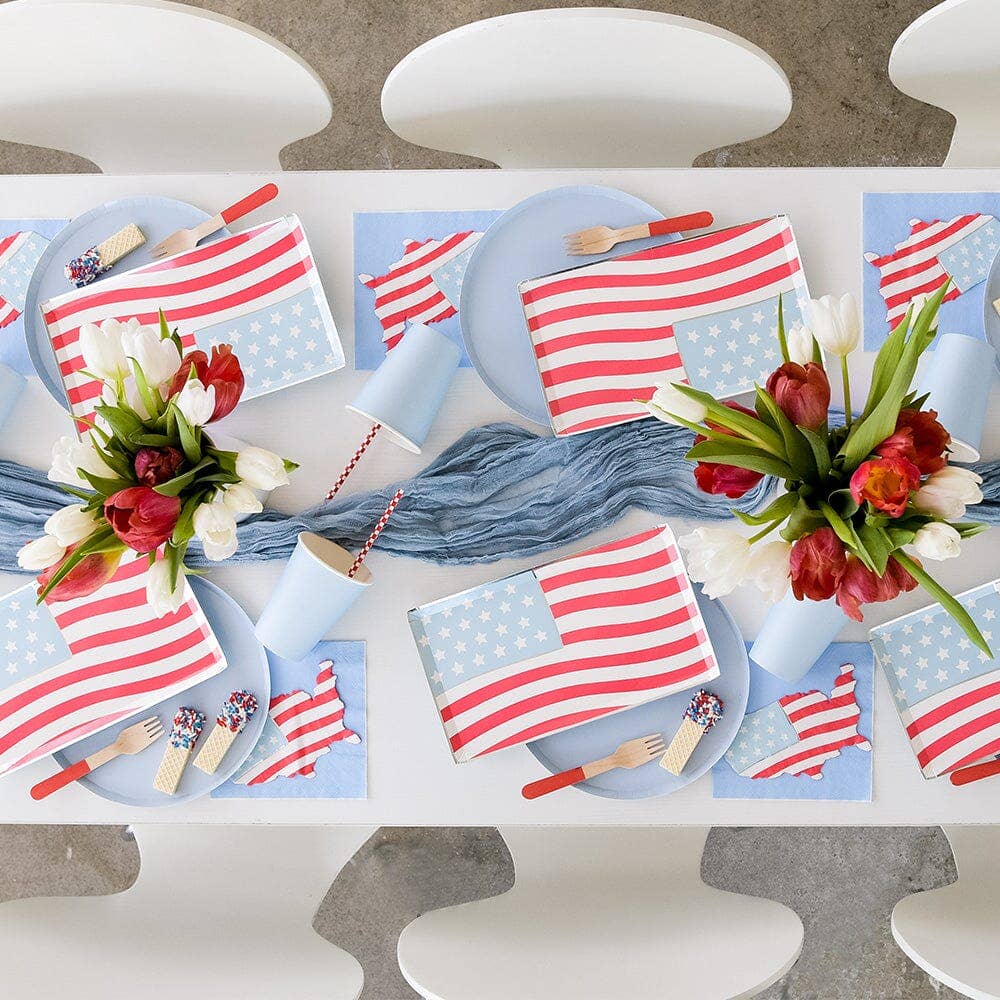 4th of July table setup with American flag plates and blue decor