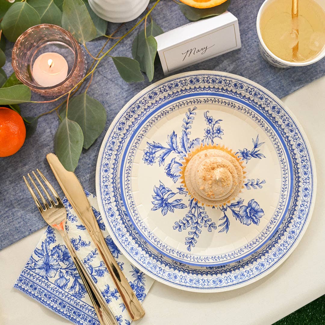 Close-up of French toile plate with dessert and layered table setting