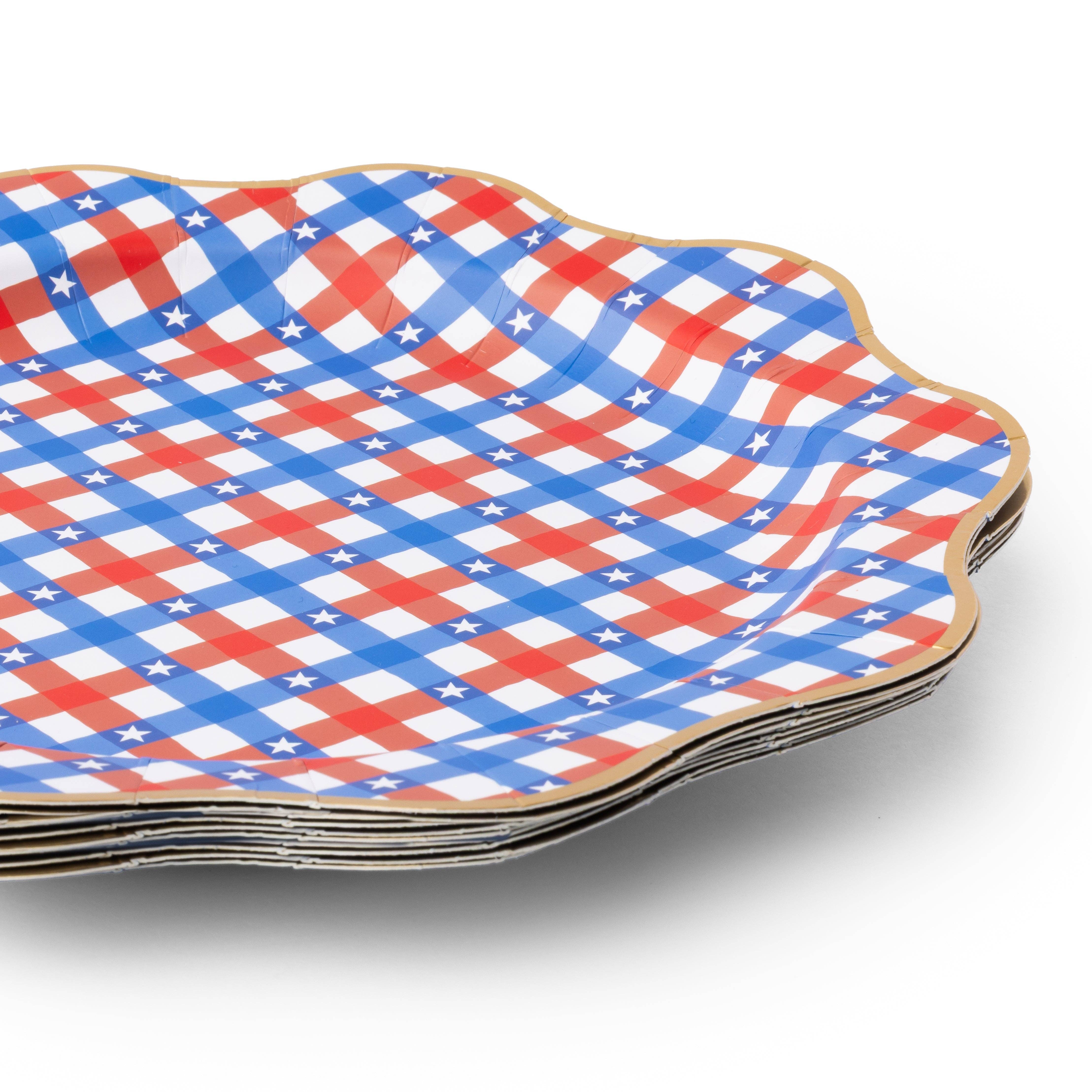 stack of red white blue gingham paper plates showing scalloped gold edge.