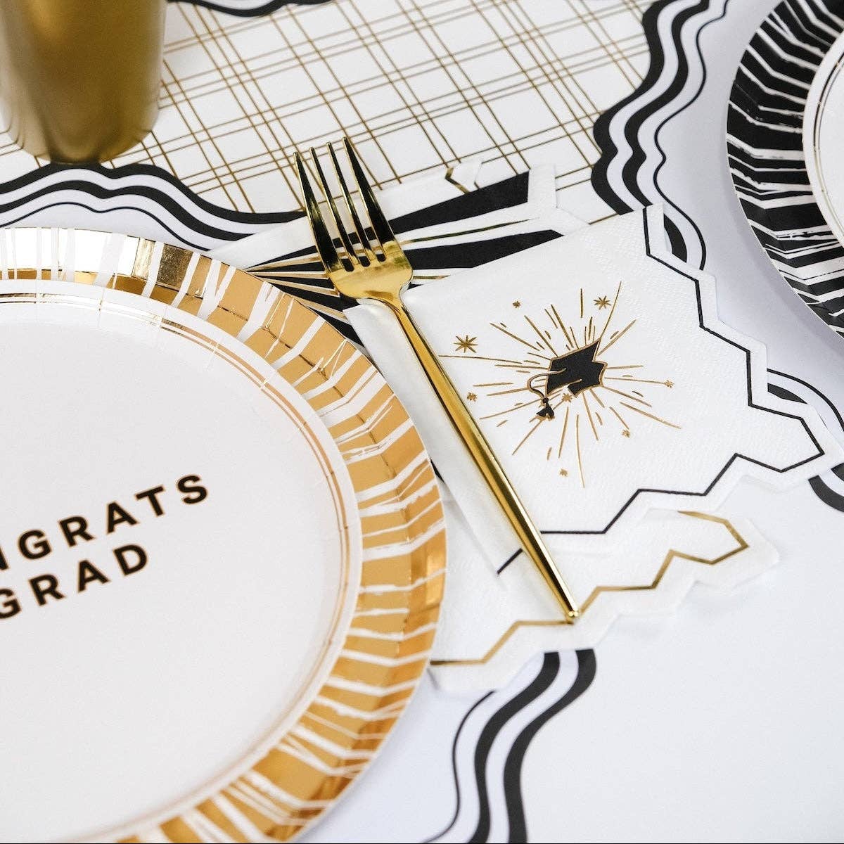 Detail shot of the gold foil starburst on a graduation cocktail napkin.