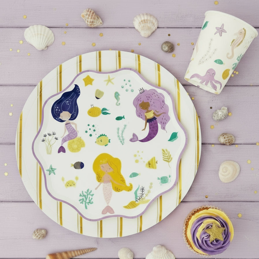 gold striped plate with mermaid themed party setup
