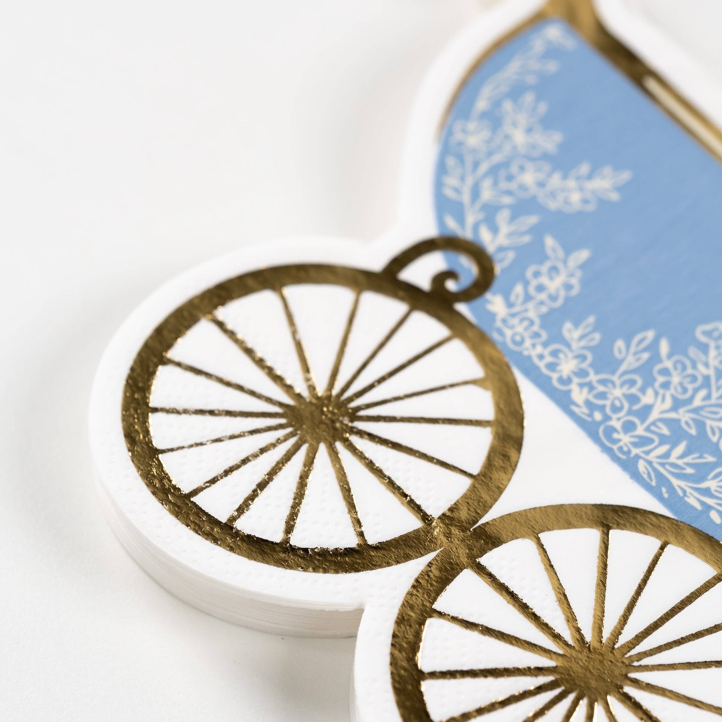 close up of gold wheel detail on carriage napkin
