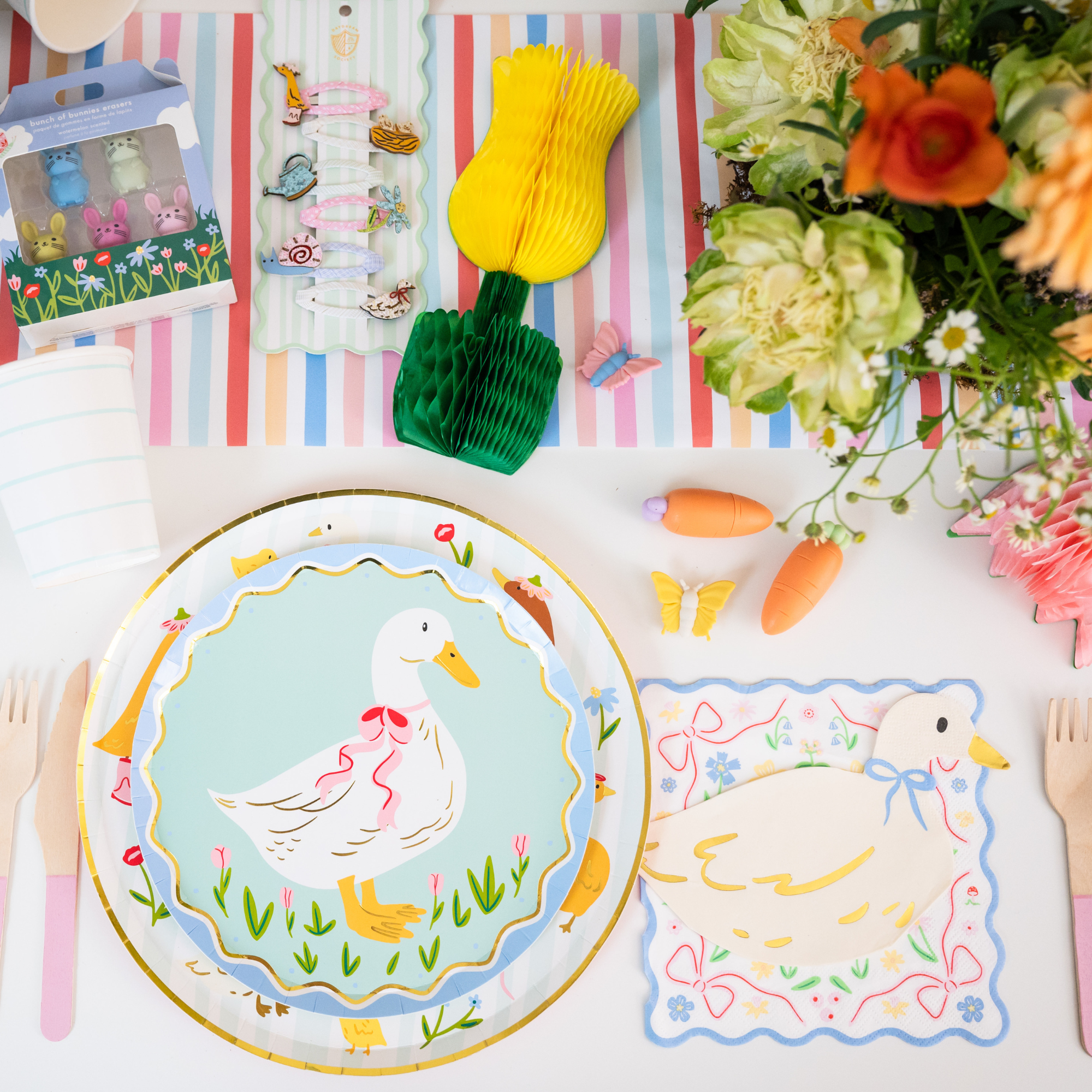 Goose themed party table with silly goose plate, spring decor, and party supplies.
