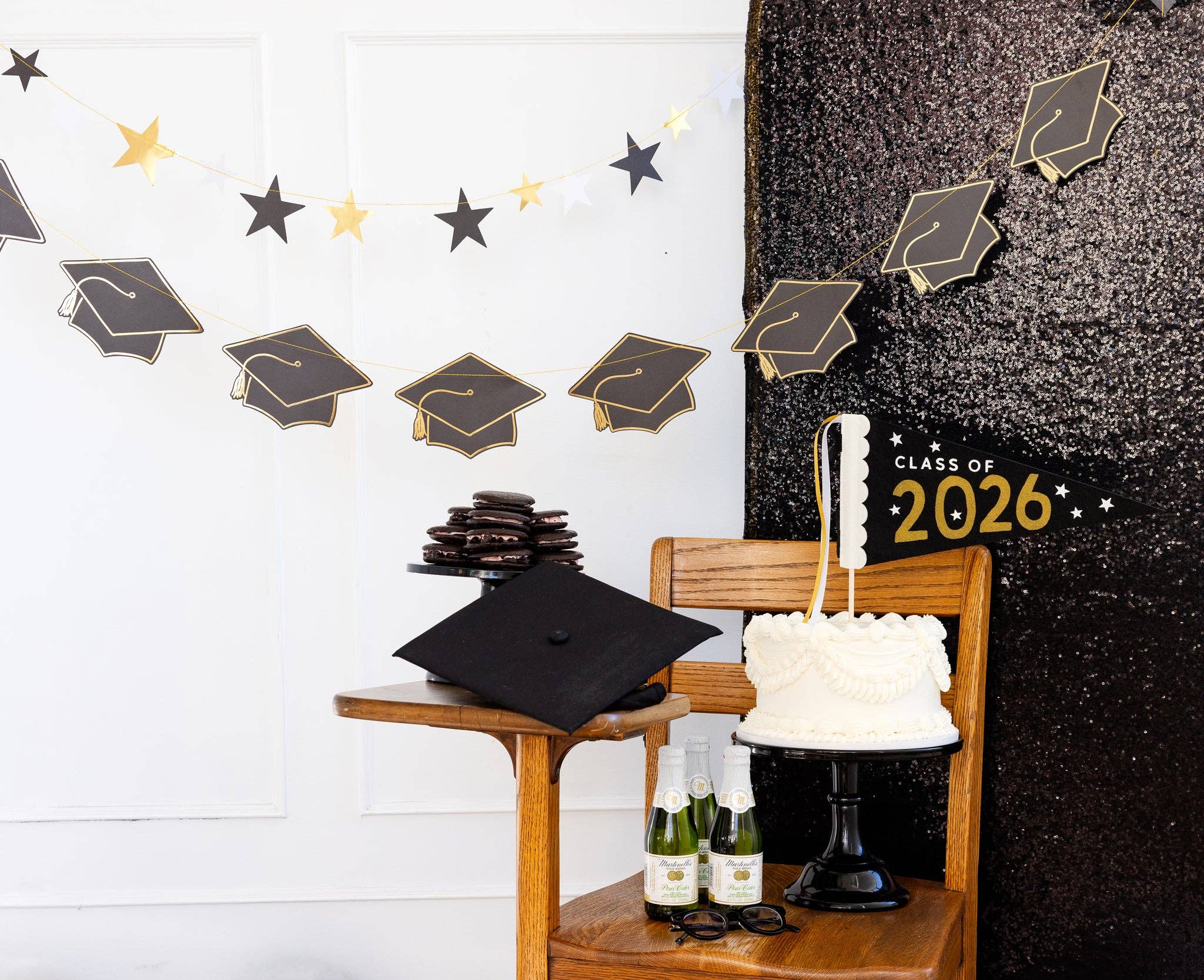 A Starry Night graduation theme display with a layered party banner set hung as a dessert table backdrop.