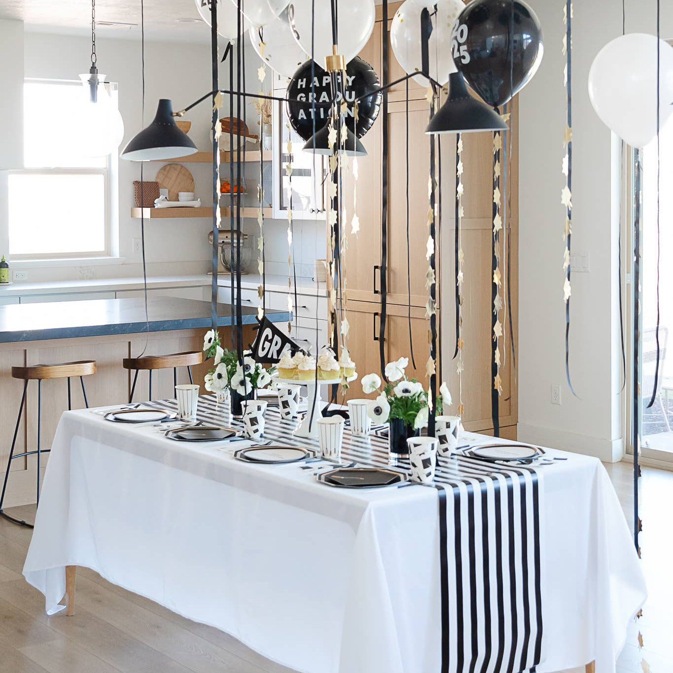 Graduation party table with hanging gold graduation garland

