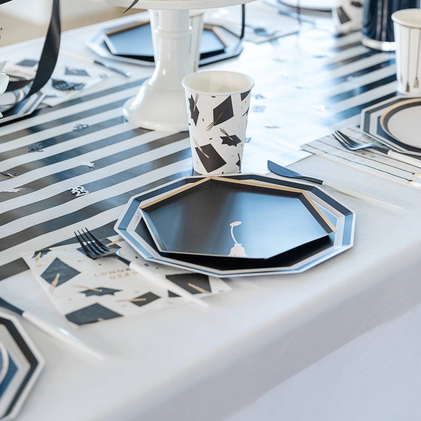 Graduation party table setting with tassel snack plates and graduation decorations