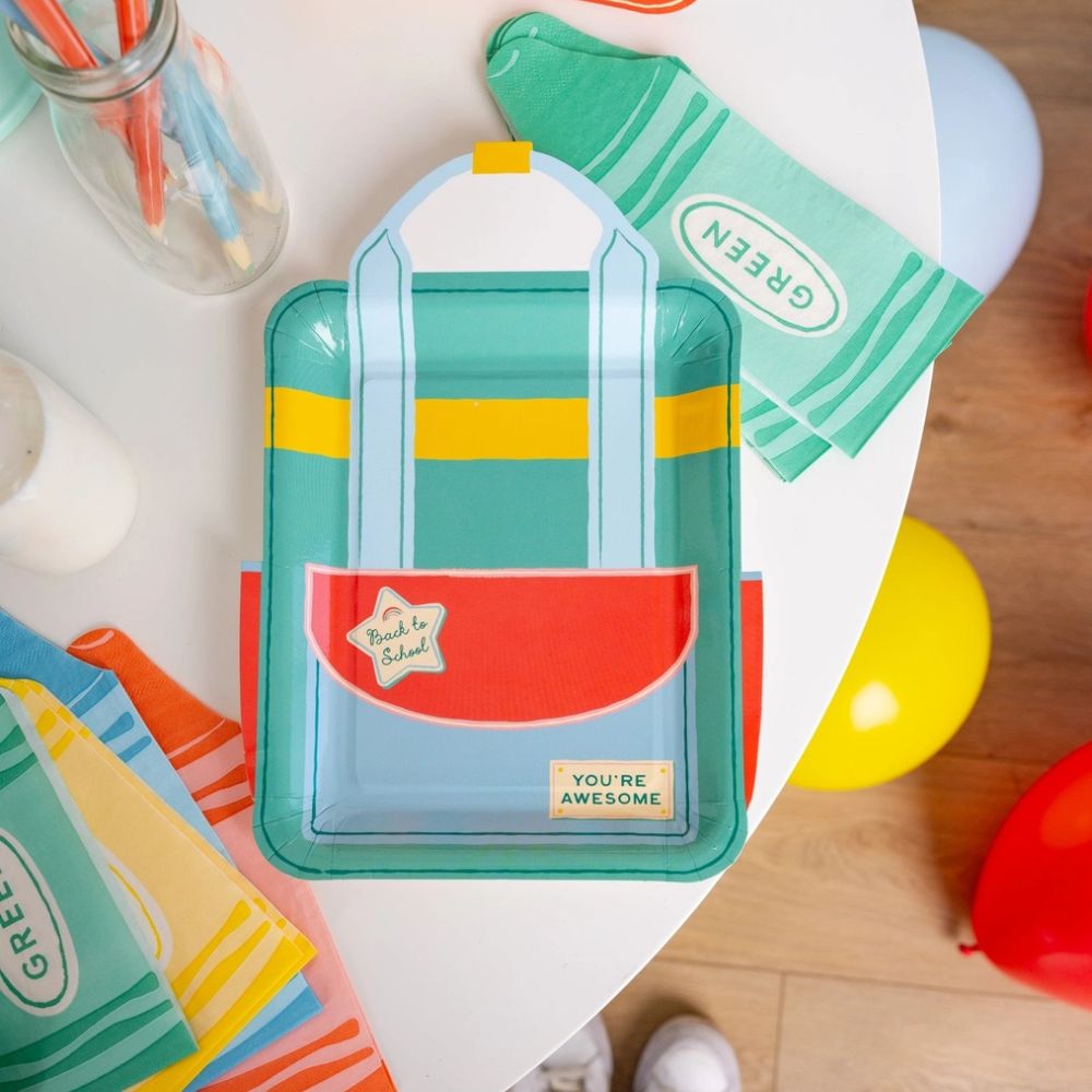 Green crayon shaped napkin with backpack plate