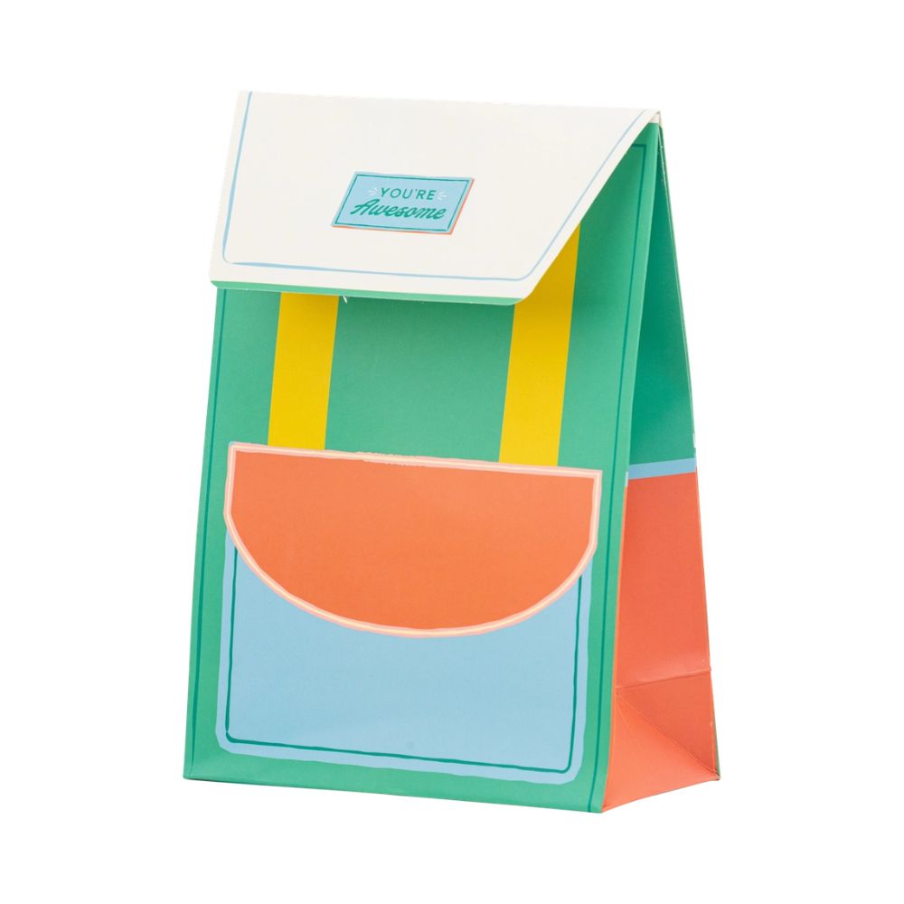 Green and yellow backpack-shaped treat bag angled view.